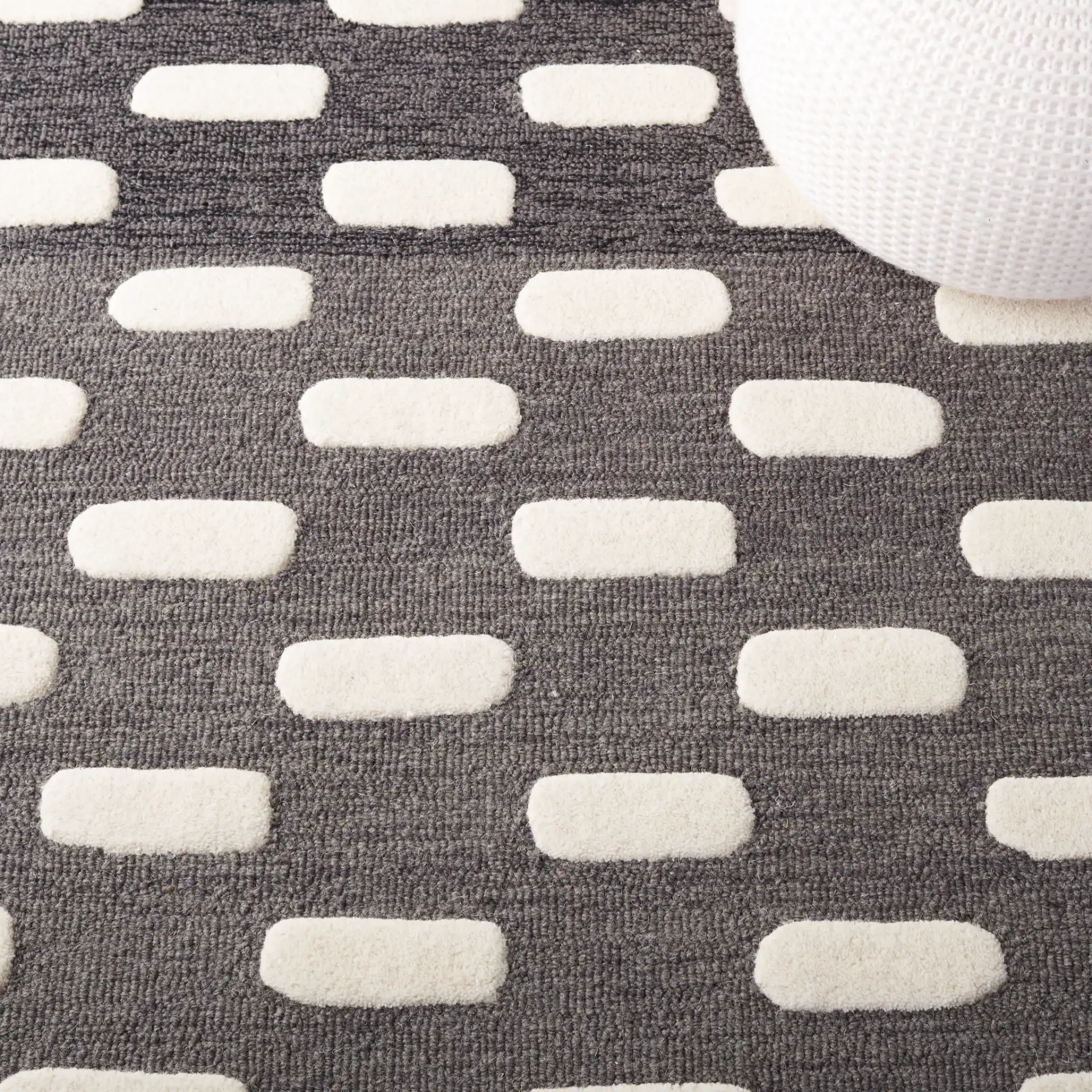 Metro Gradient Dash Hand-Tufted Wool Rug in Black / Ivory in a styled room