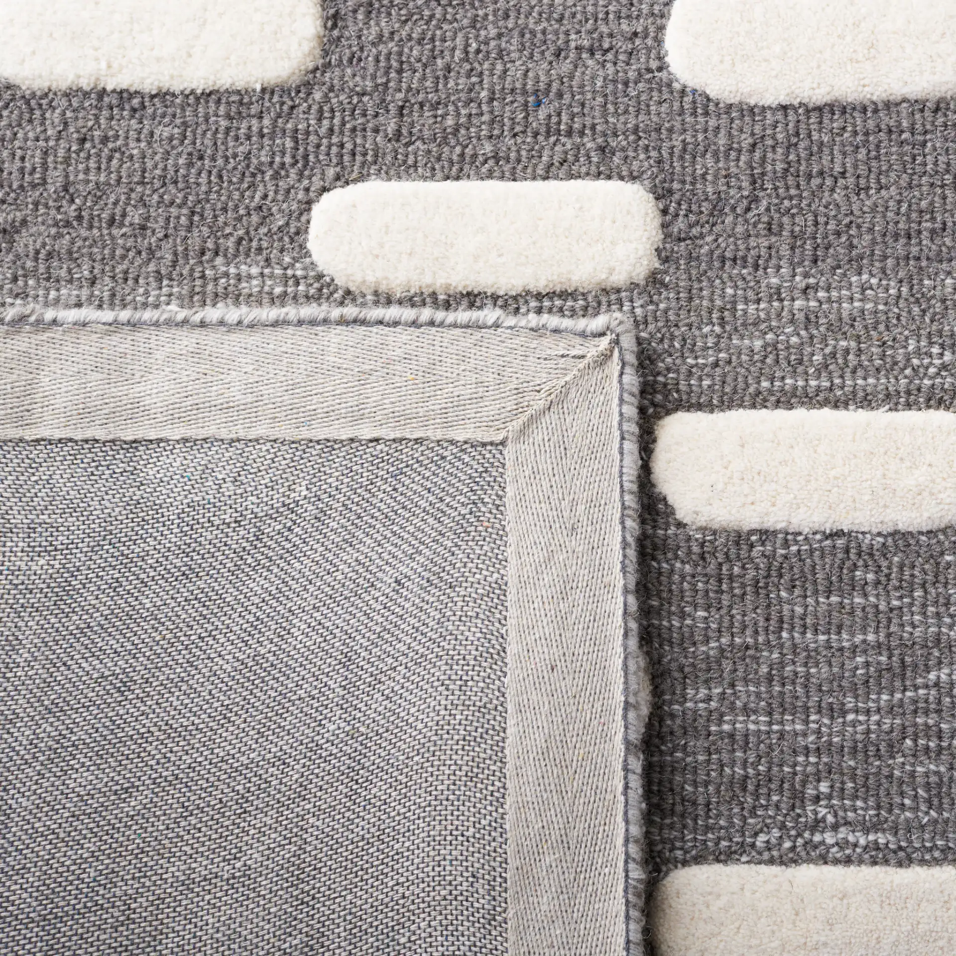Metro Gradient Dash Hand-Tufted Wool Rug in Black / Ivory in a styled room