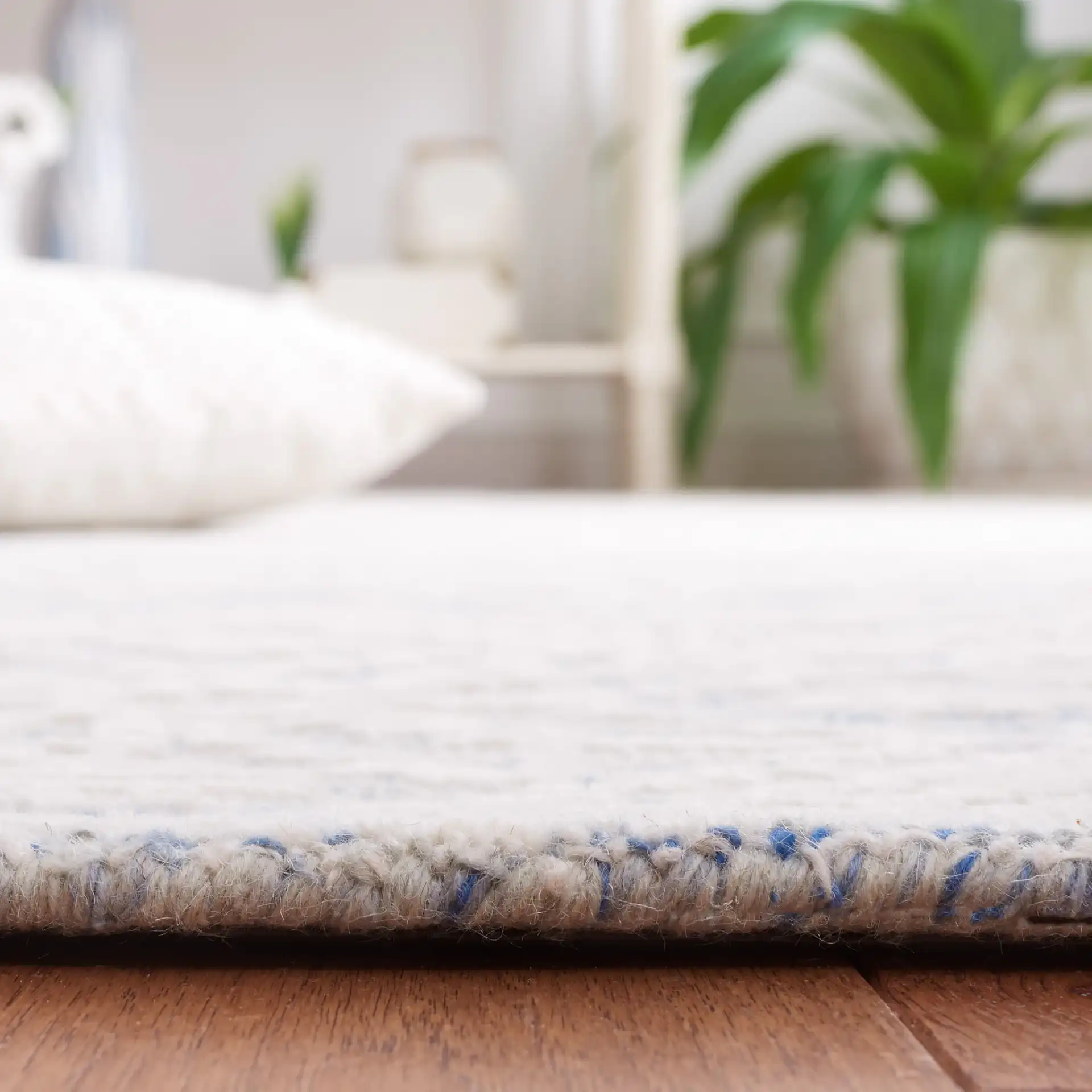 Metro Mottled Allover Hand-Tufted Wool Rug in Blue / Ivory in a styled room