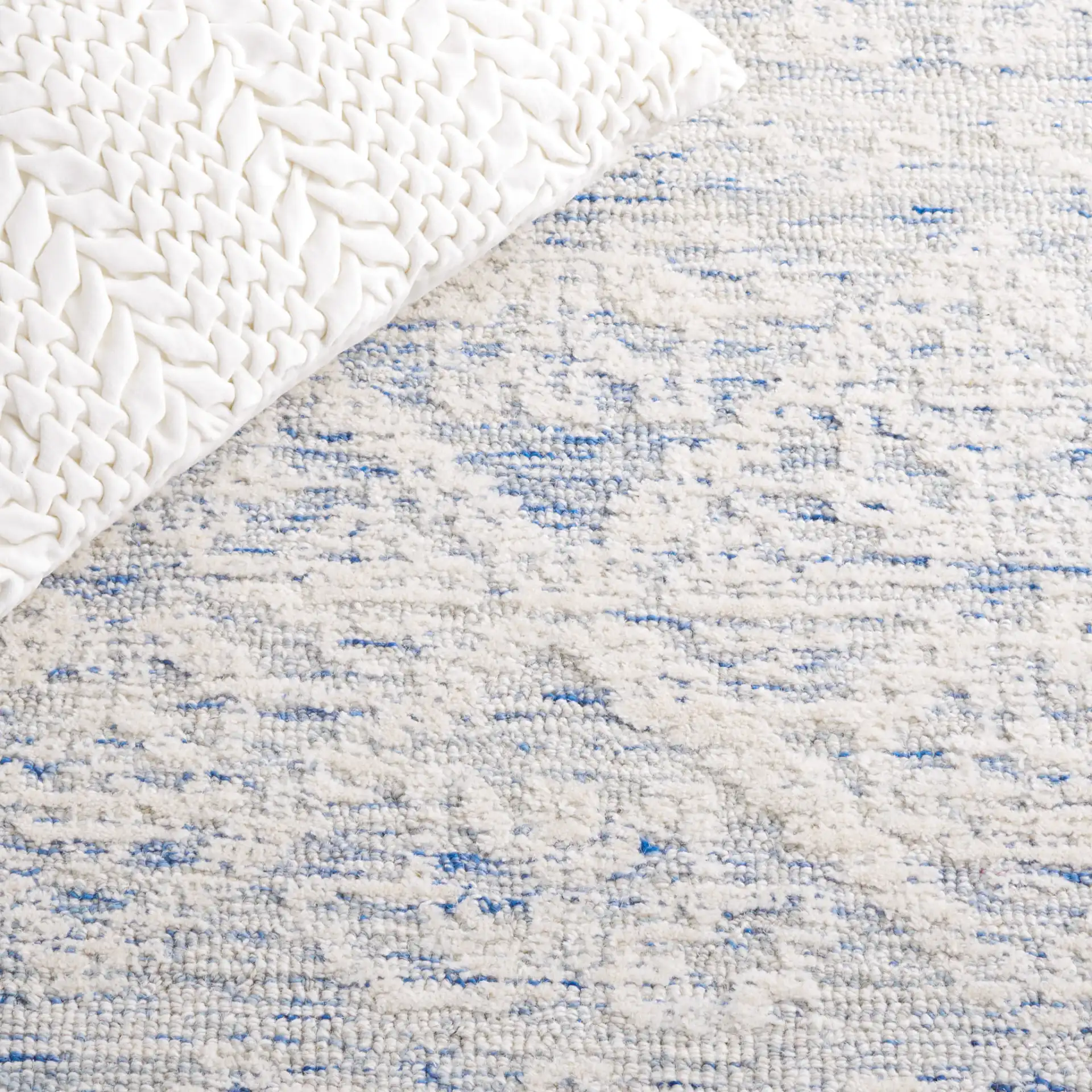 Metro Mottled Allover Hand-Tufted Wool Rug in Blue / Ivory in a styled room