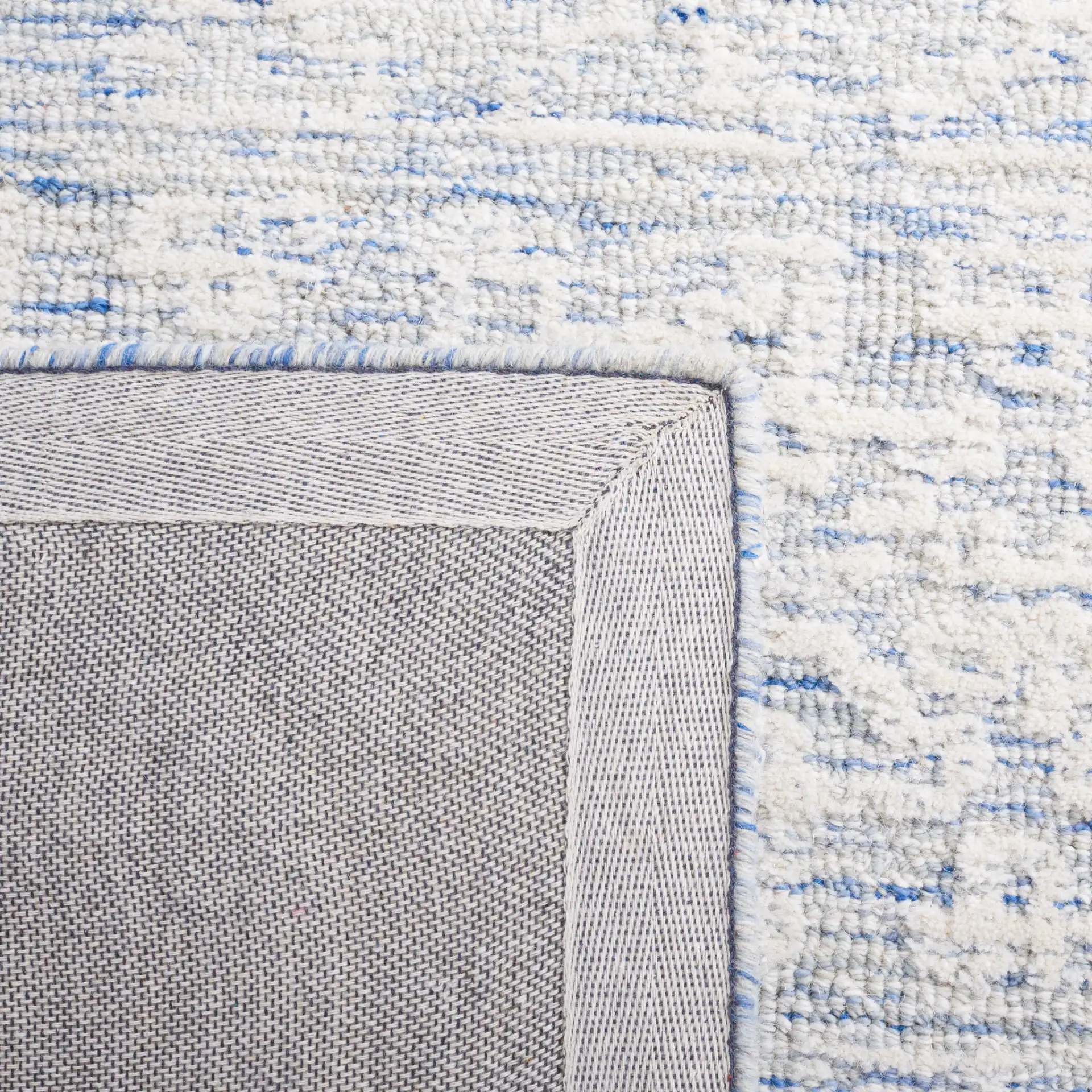 Metro Mottled Allover Hand-Tufted Wool Rug in Blue / Ivory in a styled room