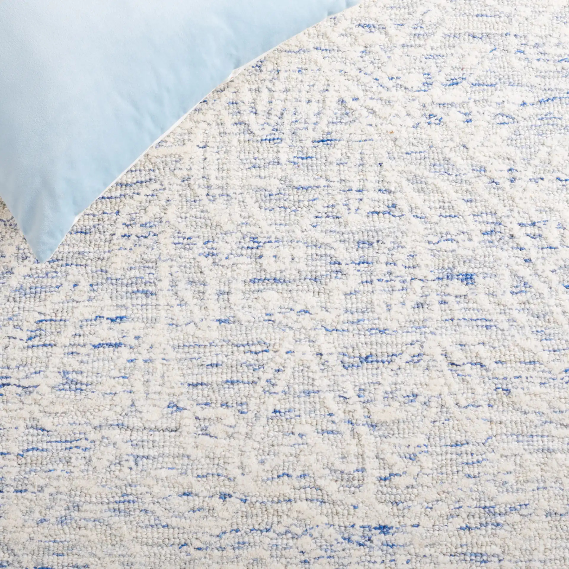 Metro Damask Trellis Hand-Tufted Wool Rug in Blue / Ivory in a styled room