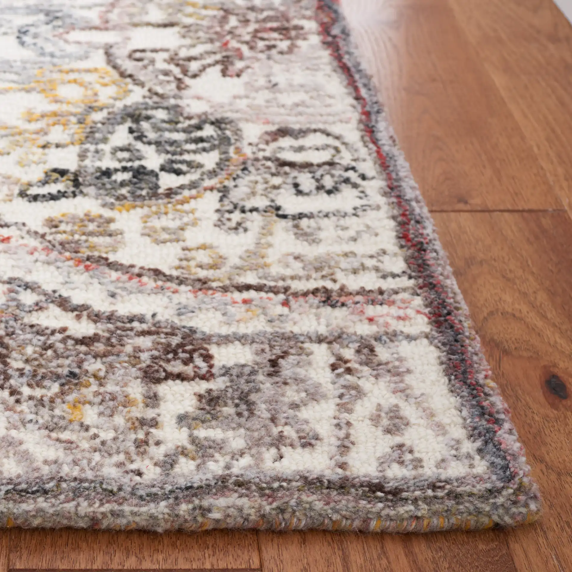 Metro Overlapping Medallion Hand-Tufted Wool Rug in Ivory / Red in a styled room