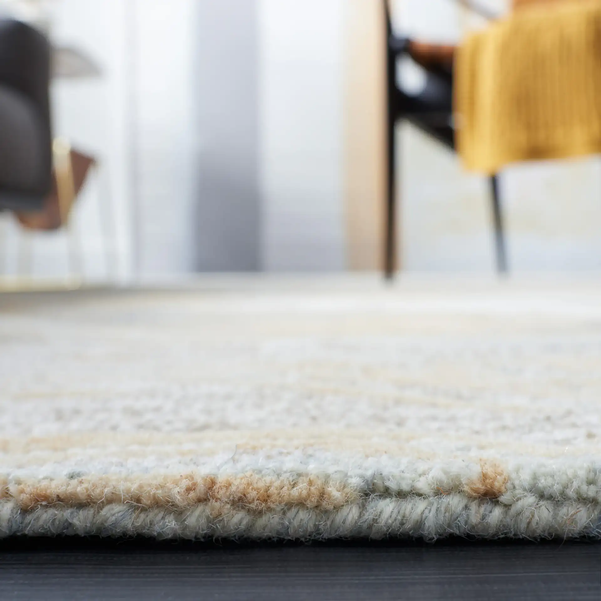 Metro Abstract Striated Hand-Tufted Wool Rug in Natural / Gold in a styled room