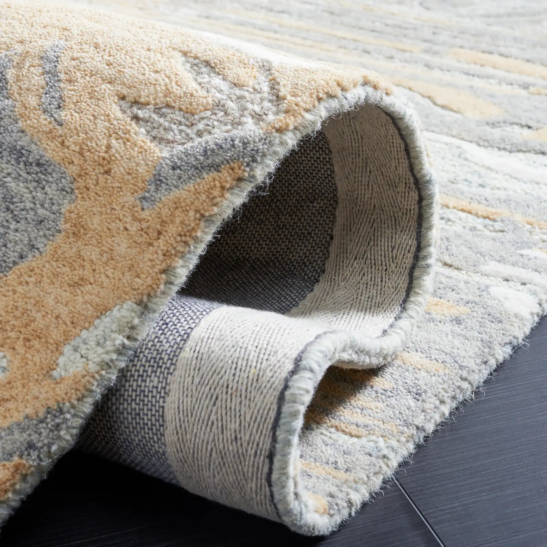 Metro Abstract Striated Hand-Tufted Wool Rug in Natural / Gold in a styled room