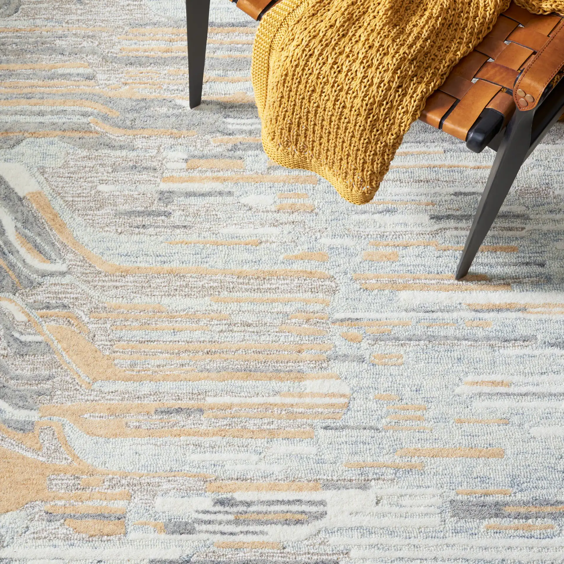 Metro Abstract Striated Hand-Tufted Wool Rug in Natural / Gold in a styled room
