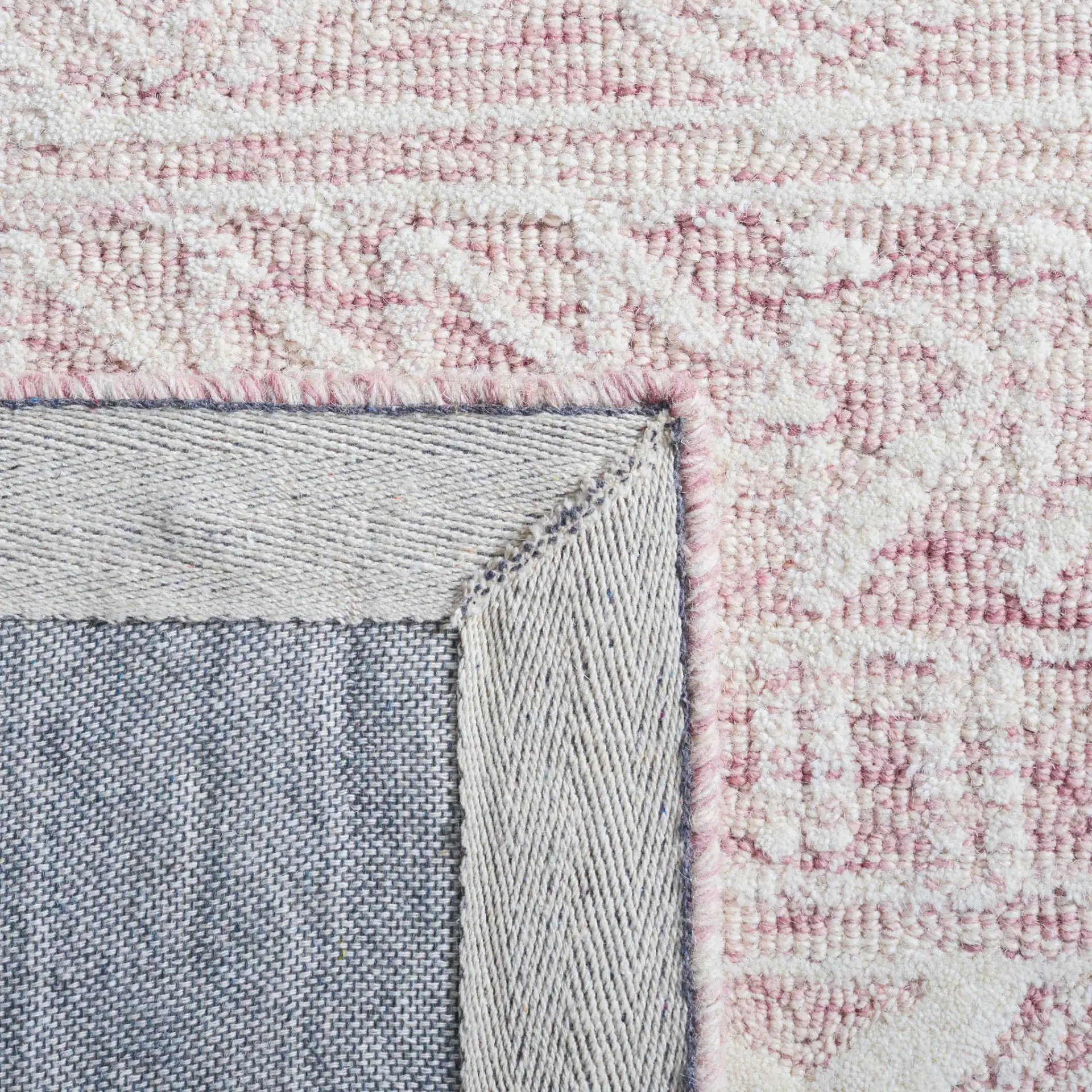 Metro Tribal Banded Hand-Tufted Wool Rug in Dark Pink / Ivory in a styled room