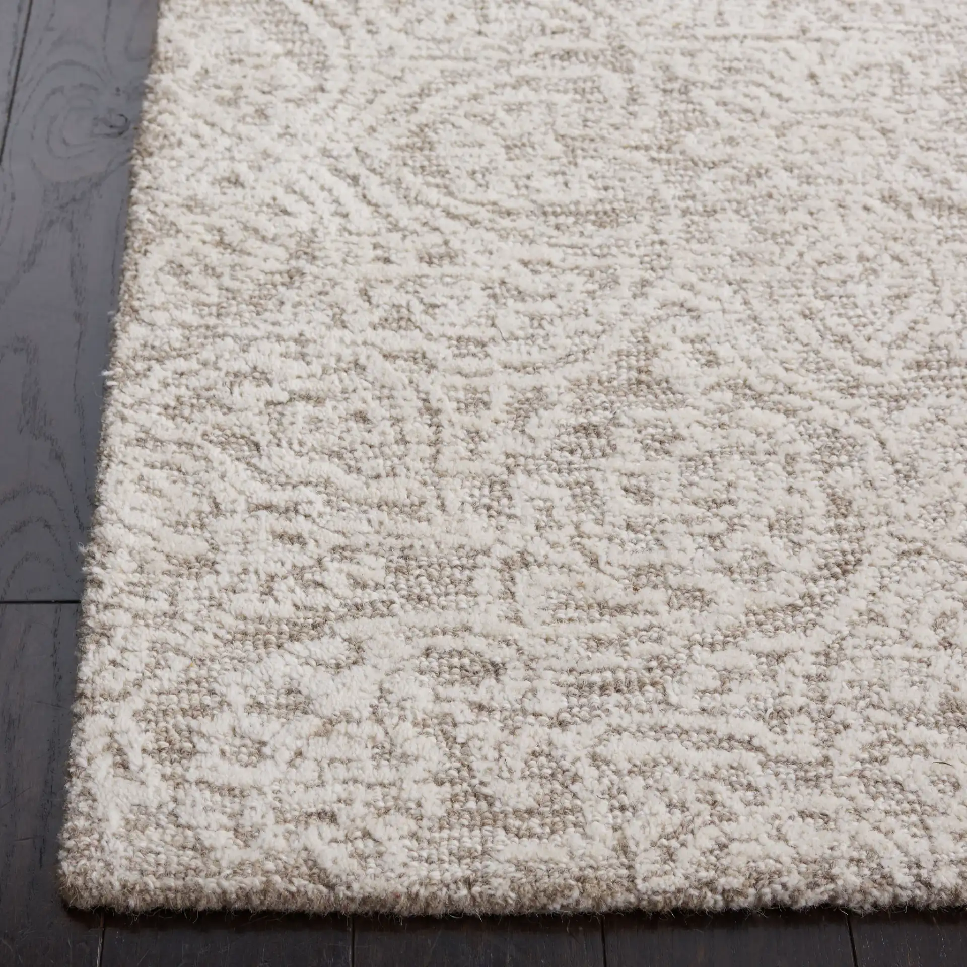Metro Distressed Damask Hand-Tufted Wool Rug in Natural / Ivory in a styled room