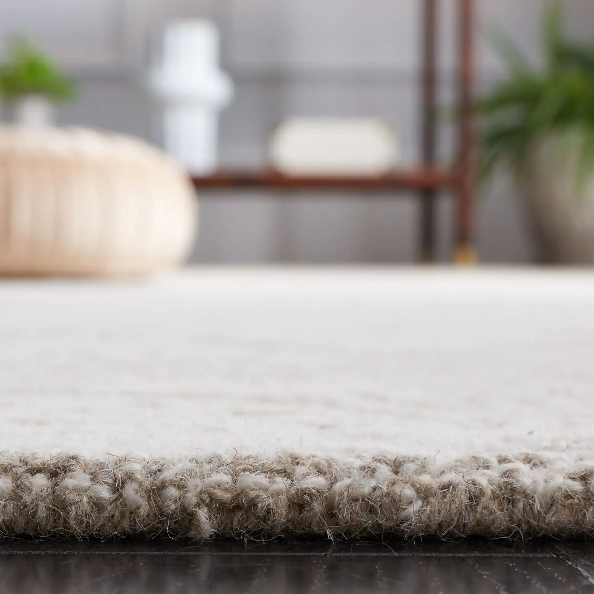 Metro Distressed Damask Hand-Tufted Wool Rug in Natural / Ivory in a styled room
