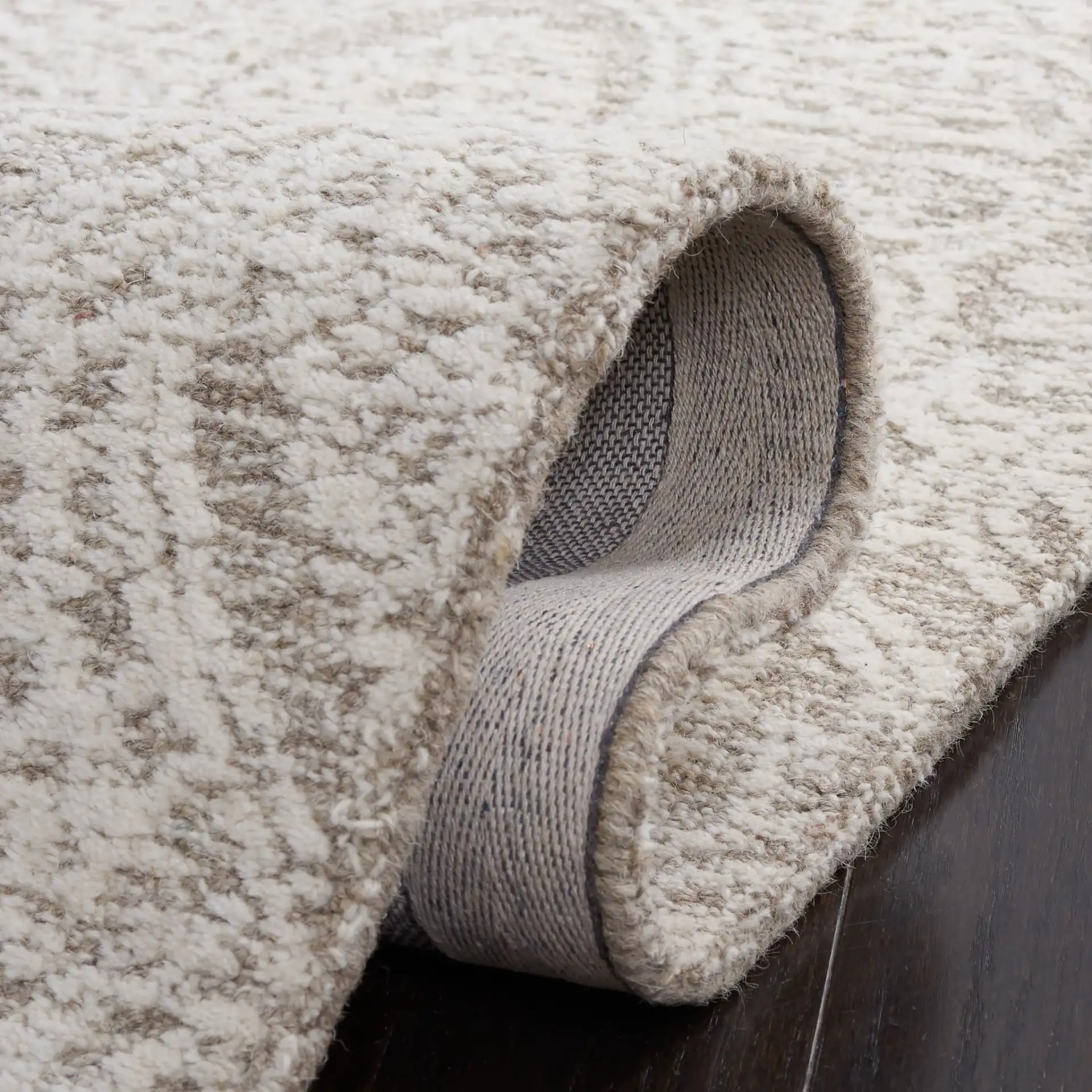 Metro Distressed Damask Hand-Tufted Wool Rug in Natural / Ivory in a styled room
