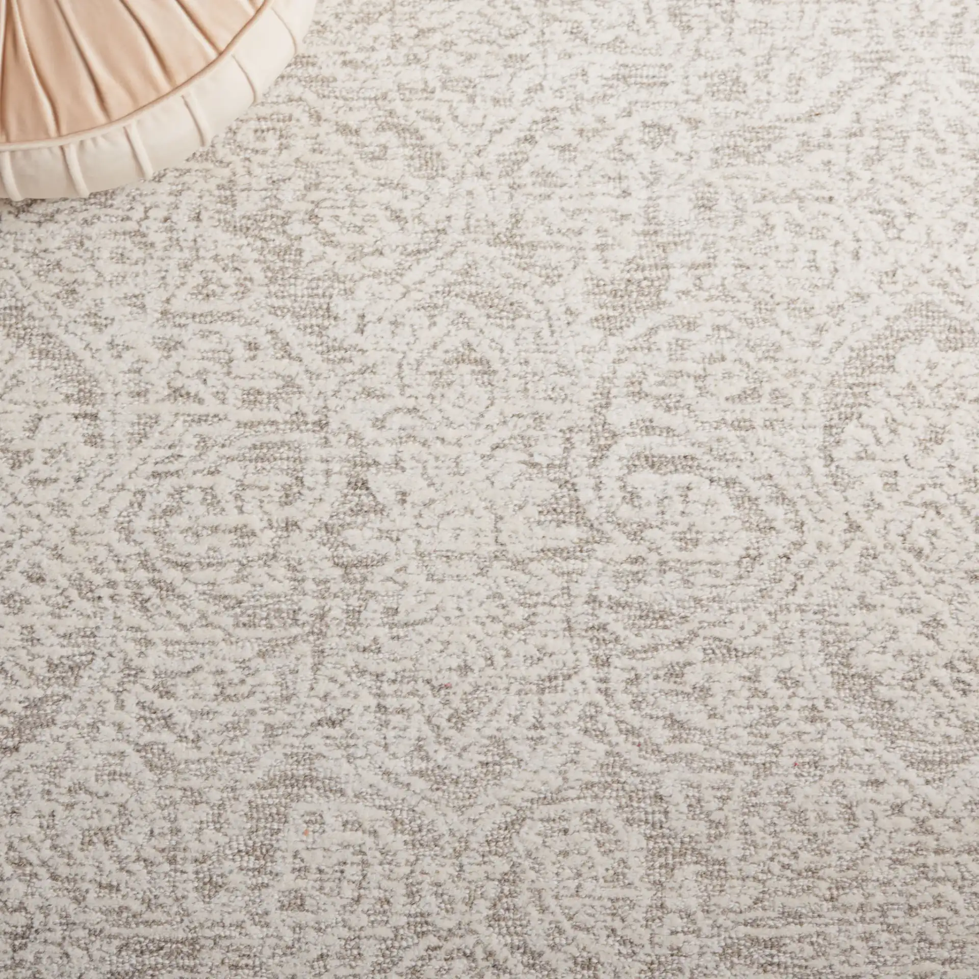 Metro Distressed Damask Hand-Tufted Wool Rug in Natural / Ivory in a styled room