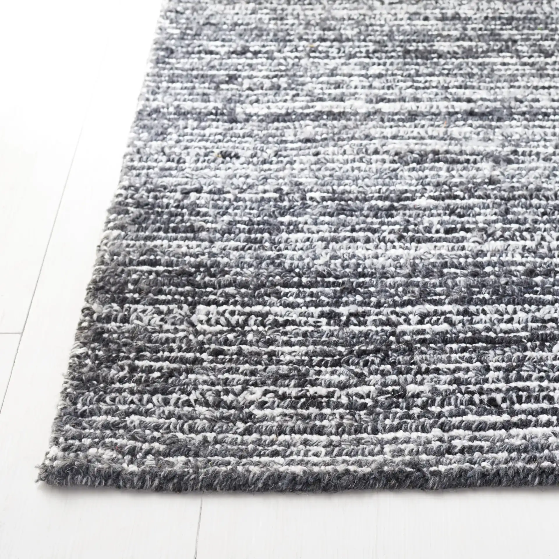 Mirage Ribbed Hand-Tufted Rug in Dark Gray / Ivory in a styled room