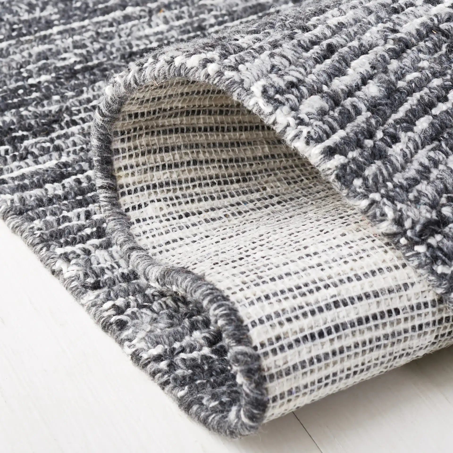 Mirage Ribbed Hand-Tufted Rug in Dark Gray / Ivory in a styled room