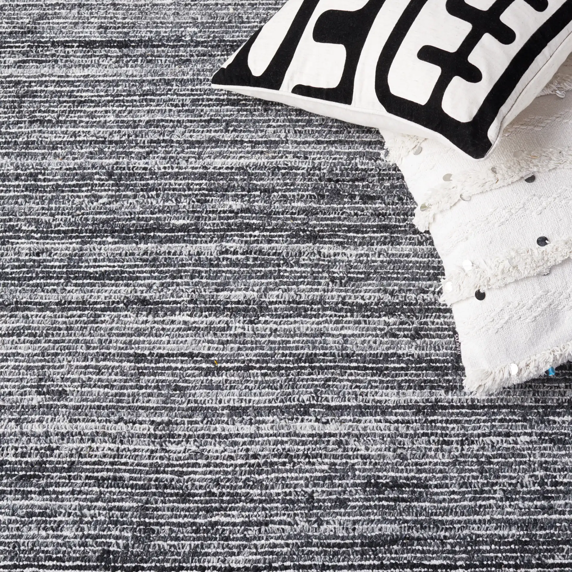 Mirage Ribbed Hand-Tufted Rug in Dark Gray / Ivory in a styled room