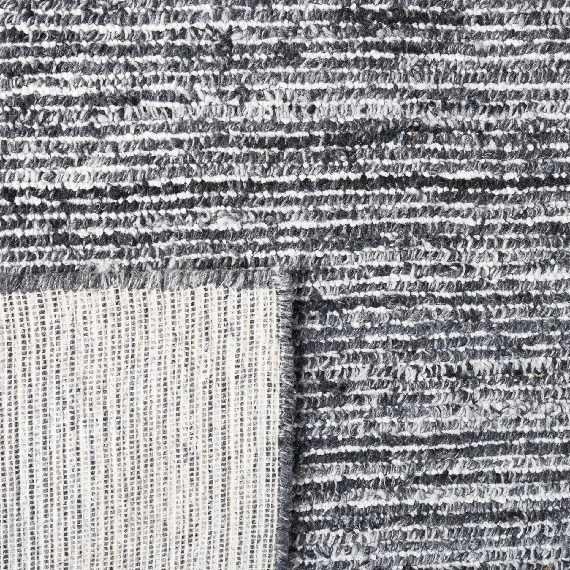 Mirage Ribbed Hand-Tufted Rug in Dark Gray / Ivory in a styled room