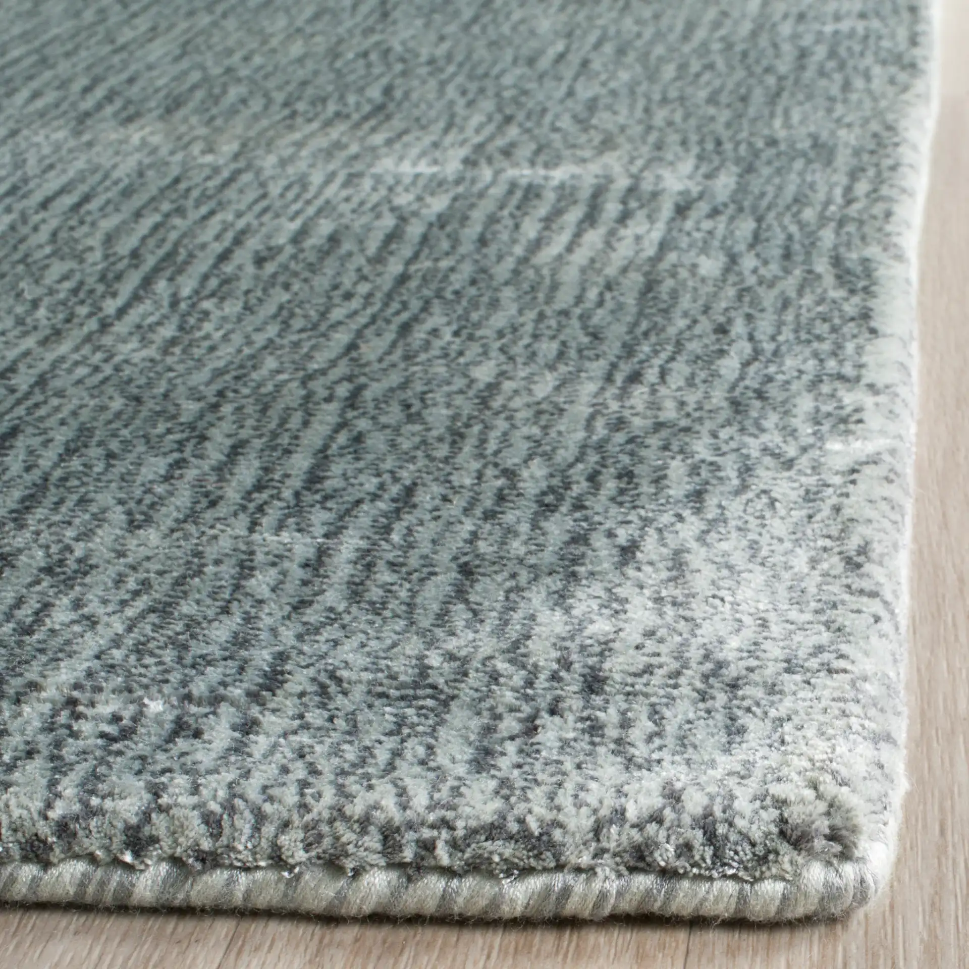 Mirage Solid Hand-Loomed Rug in Rock in a styled room