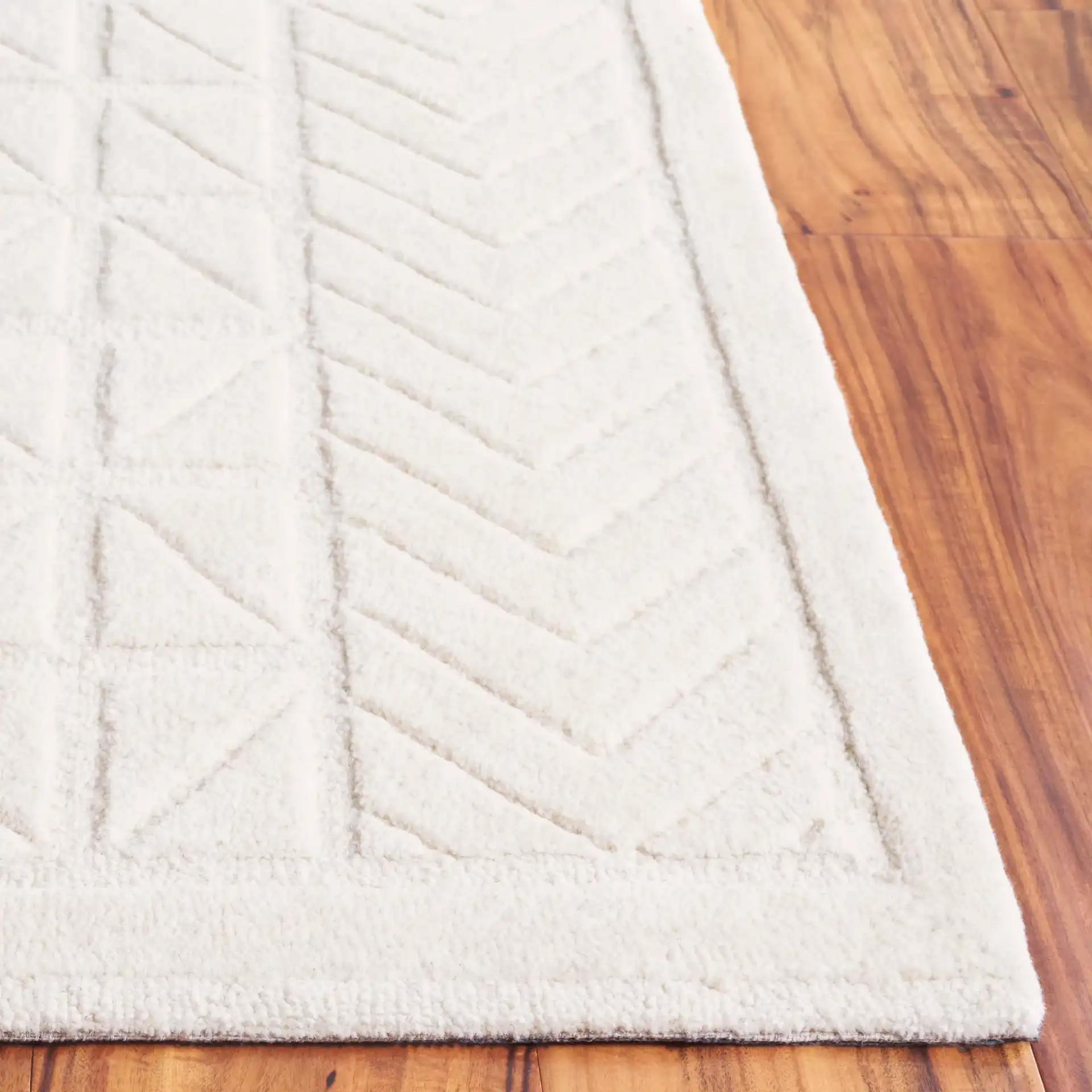 Mykonos Carved Geometric Hand-Tufted Wool Rug in Ivory in a styled room