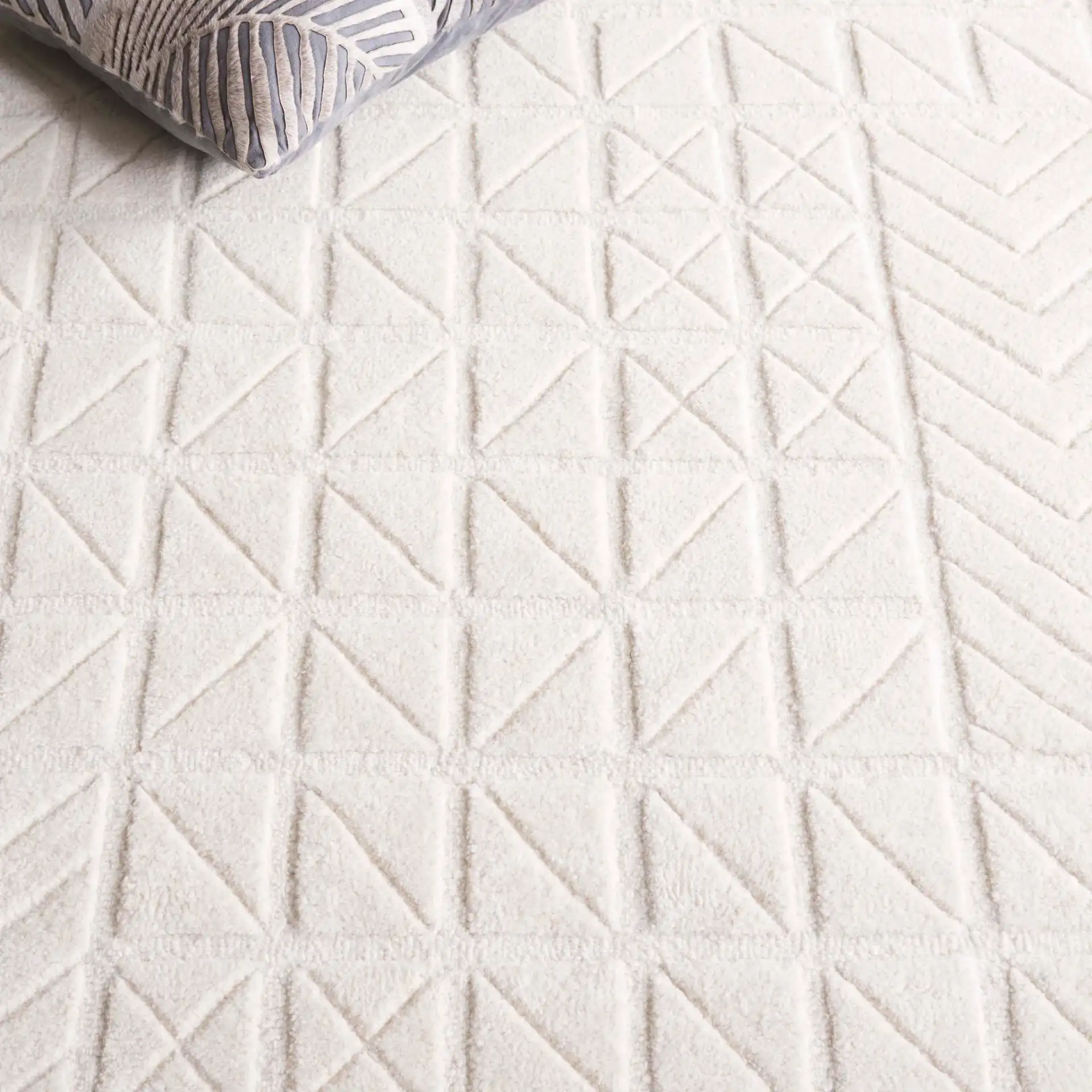 Mykonos Carved Geometric Hand-Tufted Wool Rug in Ivory in a styled room