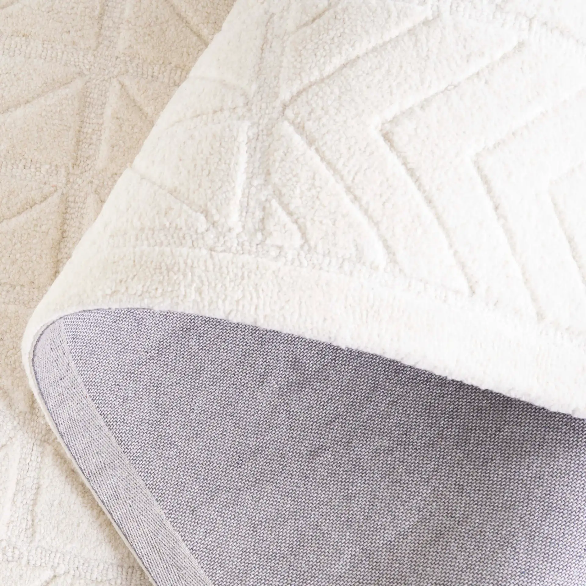 Mykonos Carved Geometric Hand-Tufted Wool Rug in Ivory in a styled room