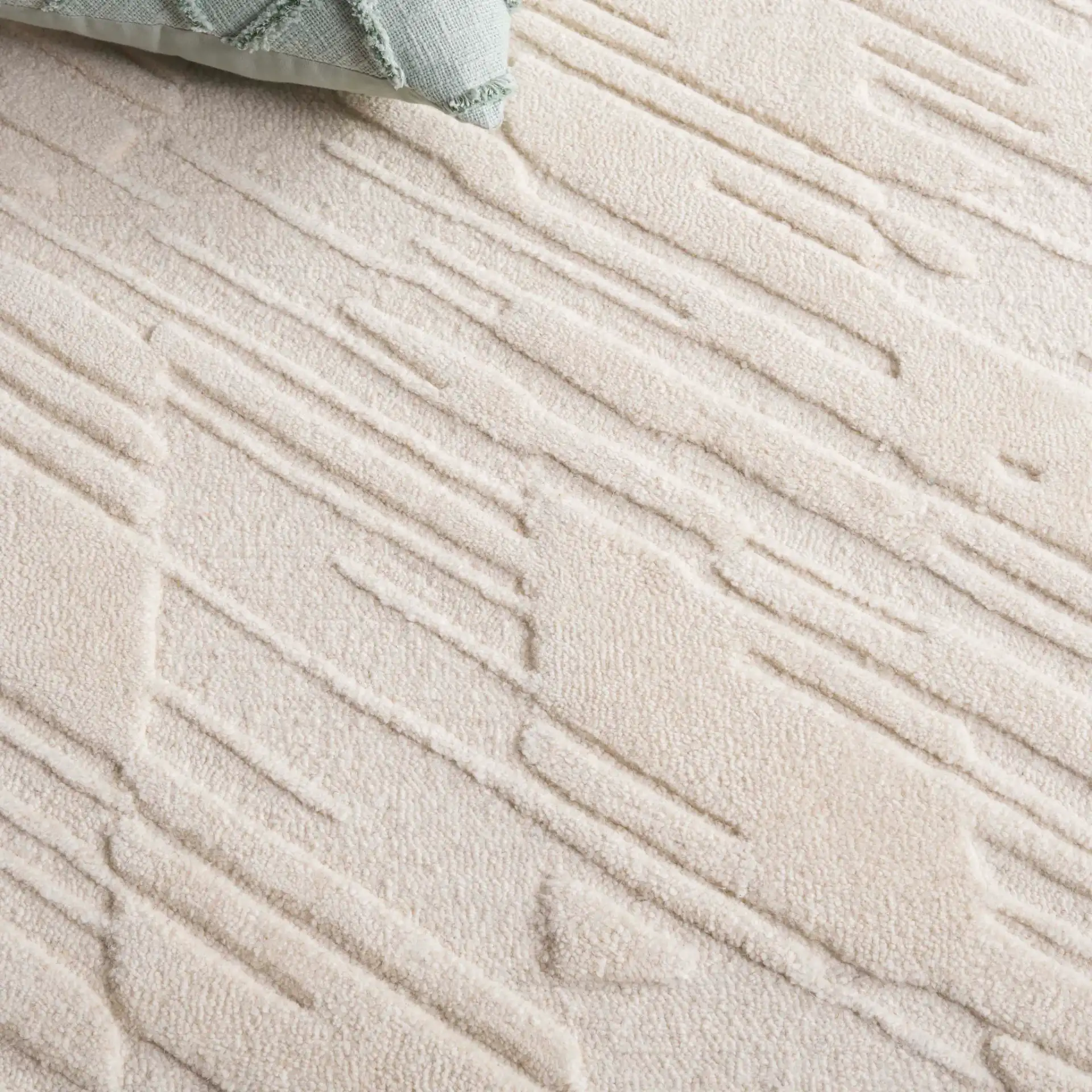 Mykonos Textured Stripe Hand-Tufted Wool Rug in Ivory in a styled room