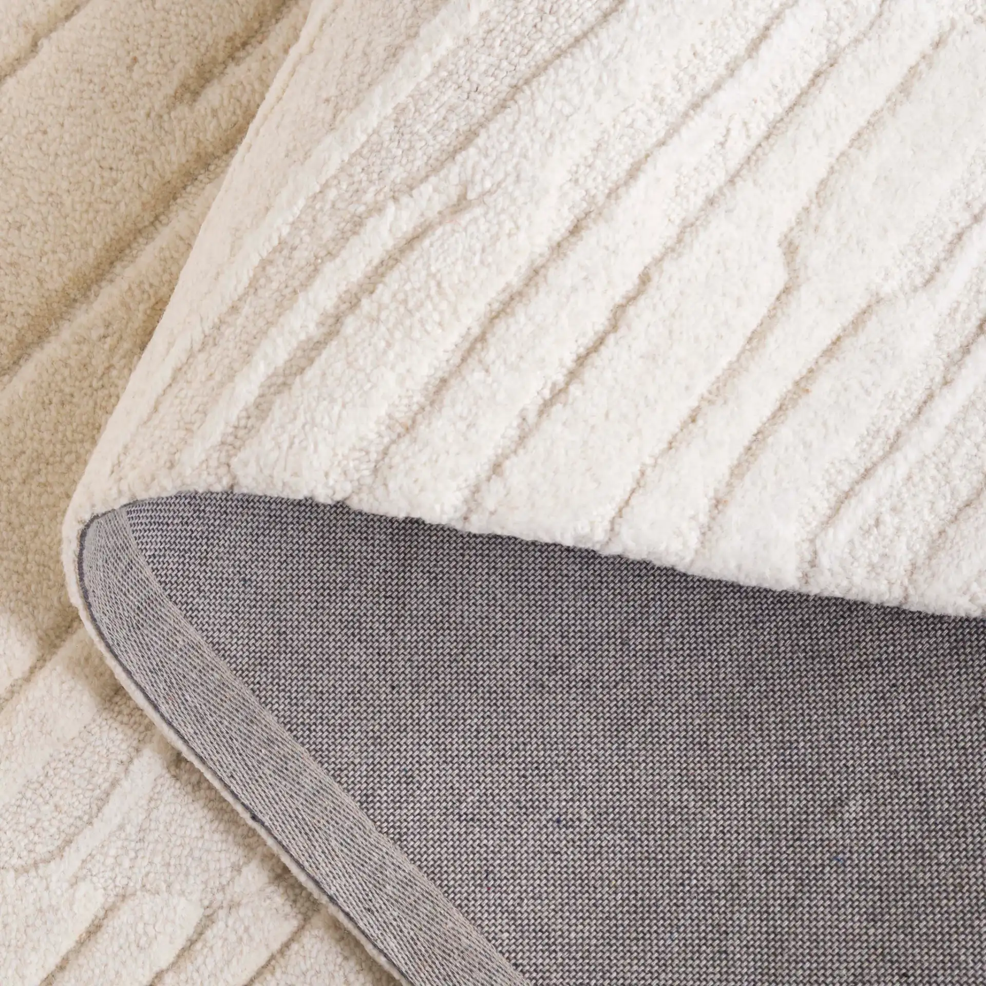 Mykonos Textured Stripe Hand-Tufted Wool Rug in Ivory in a styled room