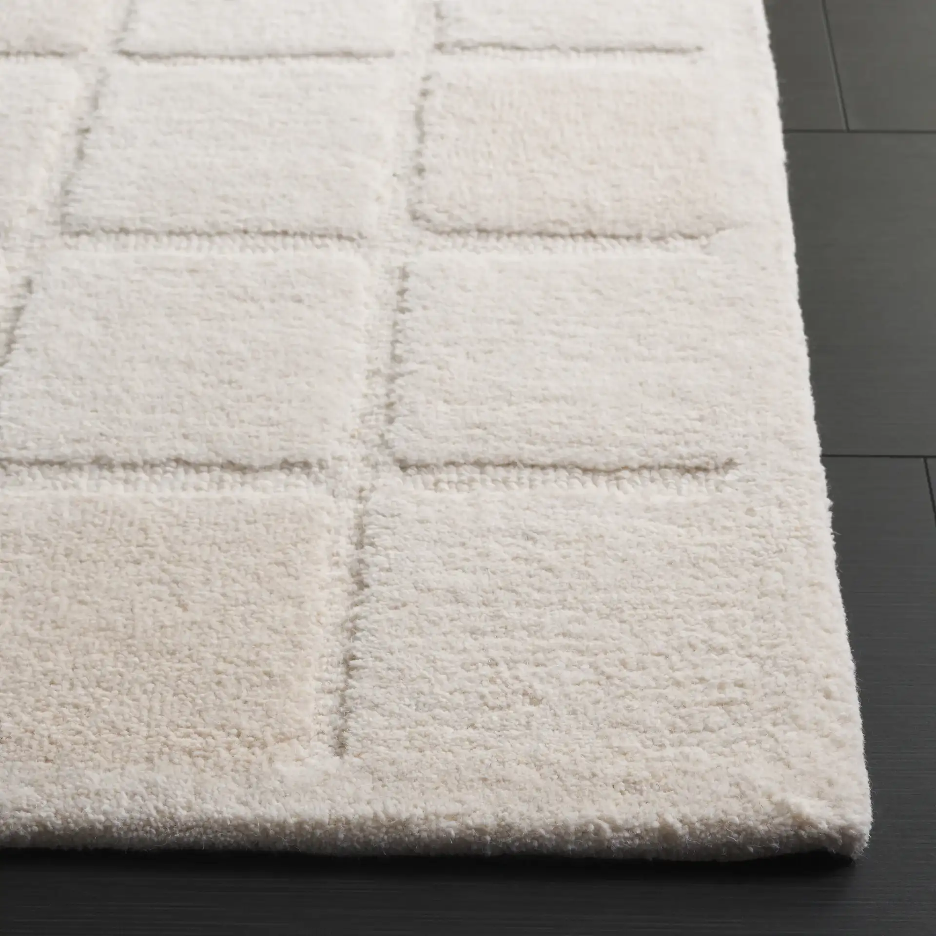 Mykonos Large-Scale Grid Hand-Tufted Wool Rug in Ivory in a styled room