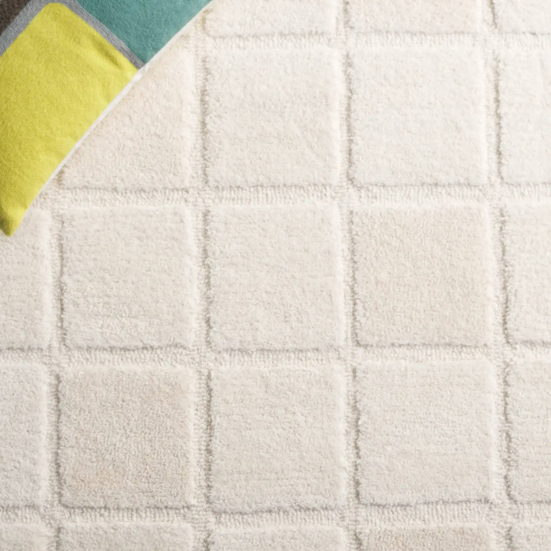 Mykonos Large-Scale Grid Hand-Tufted Wool Rug in Ivory in a styled room