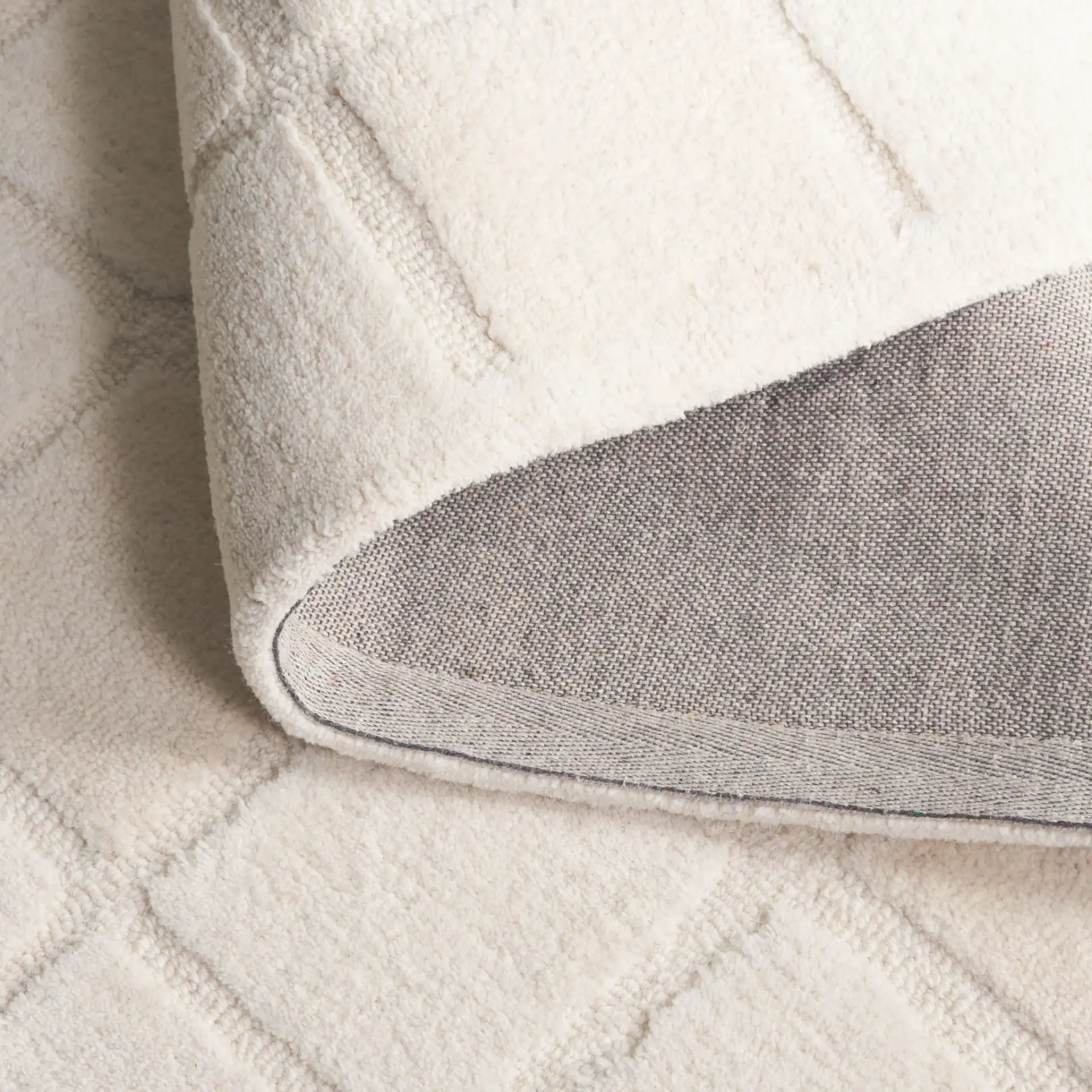 Mykonos Large-Scale Grid Hand-Tufted Wool Rug in Ivory in a styled room