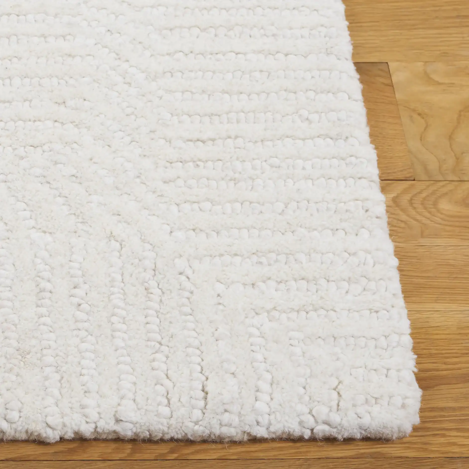 Mykonos Stepped Border Hand-Tufted Wool Rug in Ivory in a styled room