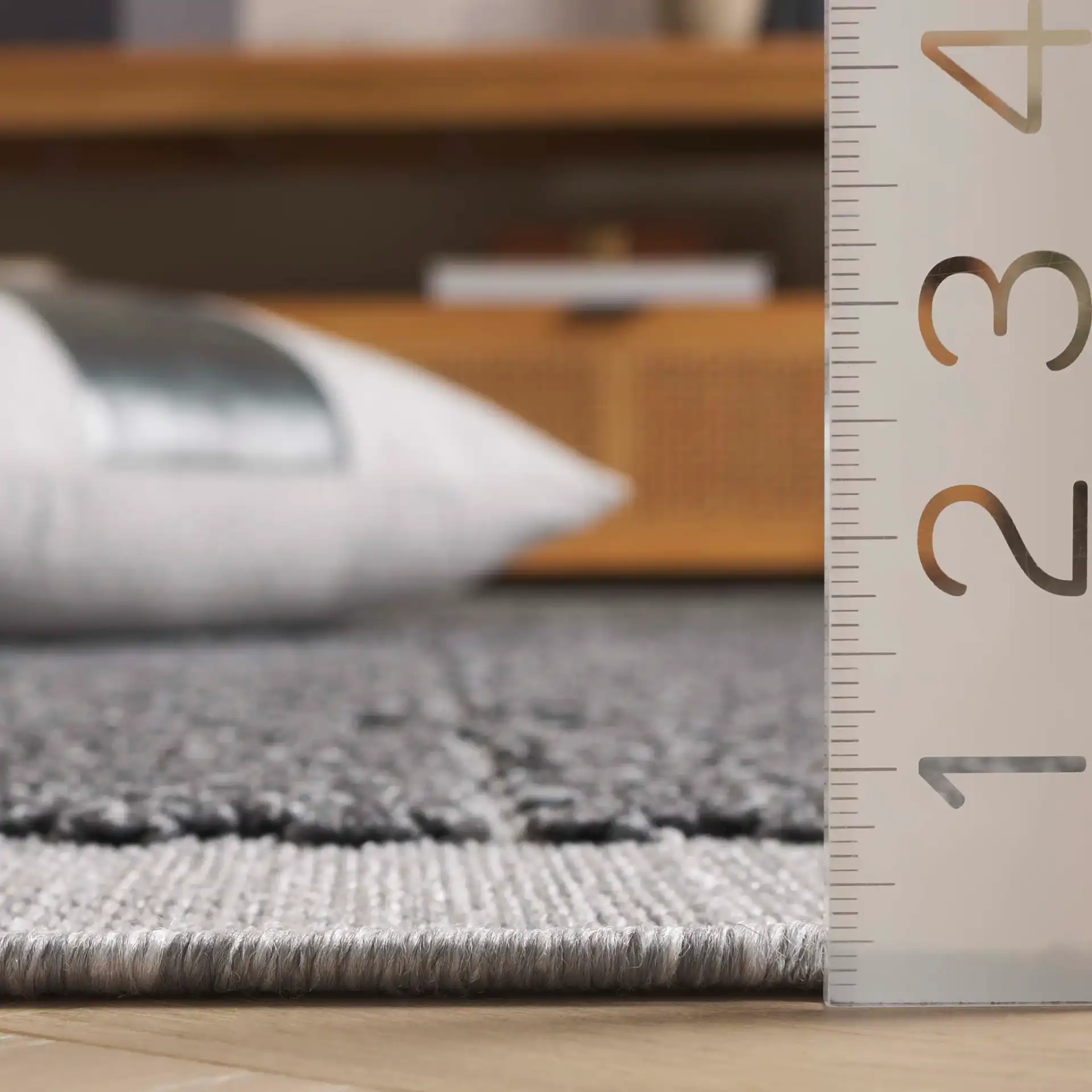 Milos Grid Border Outdoor Rug in Charcoal in a styled room