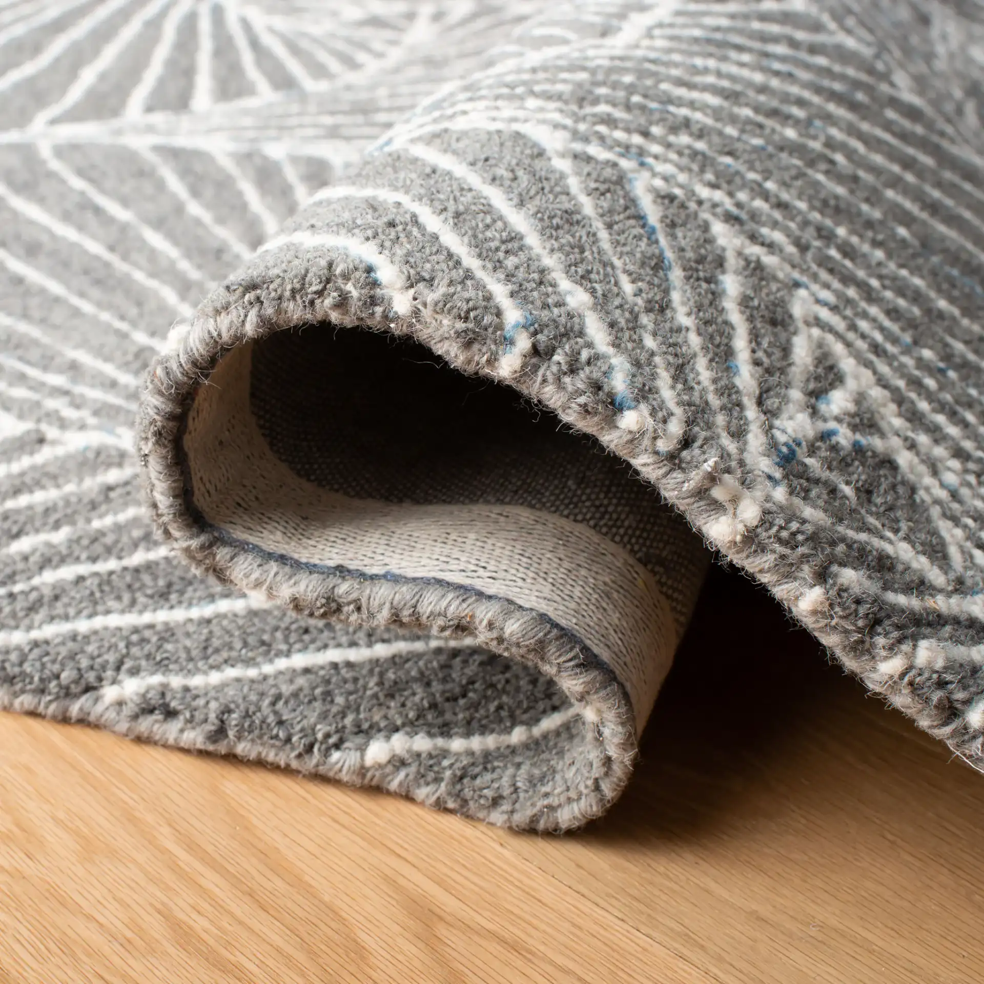 Micro-Loop Swirling Geometric Hand-Tufted Wool Rug in Gray / Ivory in a styled room