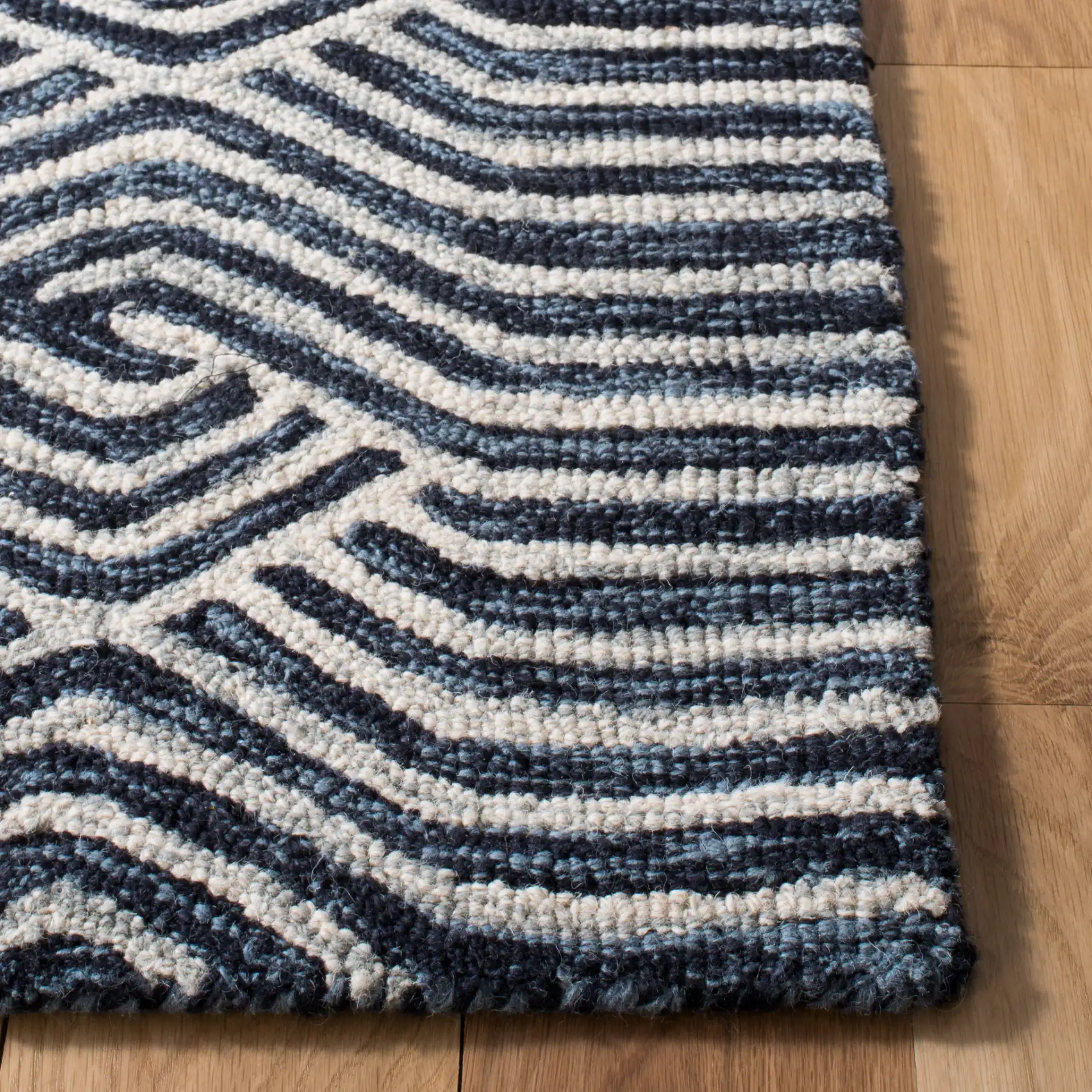 Micro-Loop Chevron Fretwork Hand-Tufted Wool Rug in Dark Blue / Ivory in a styled room