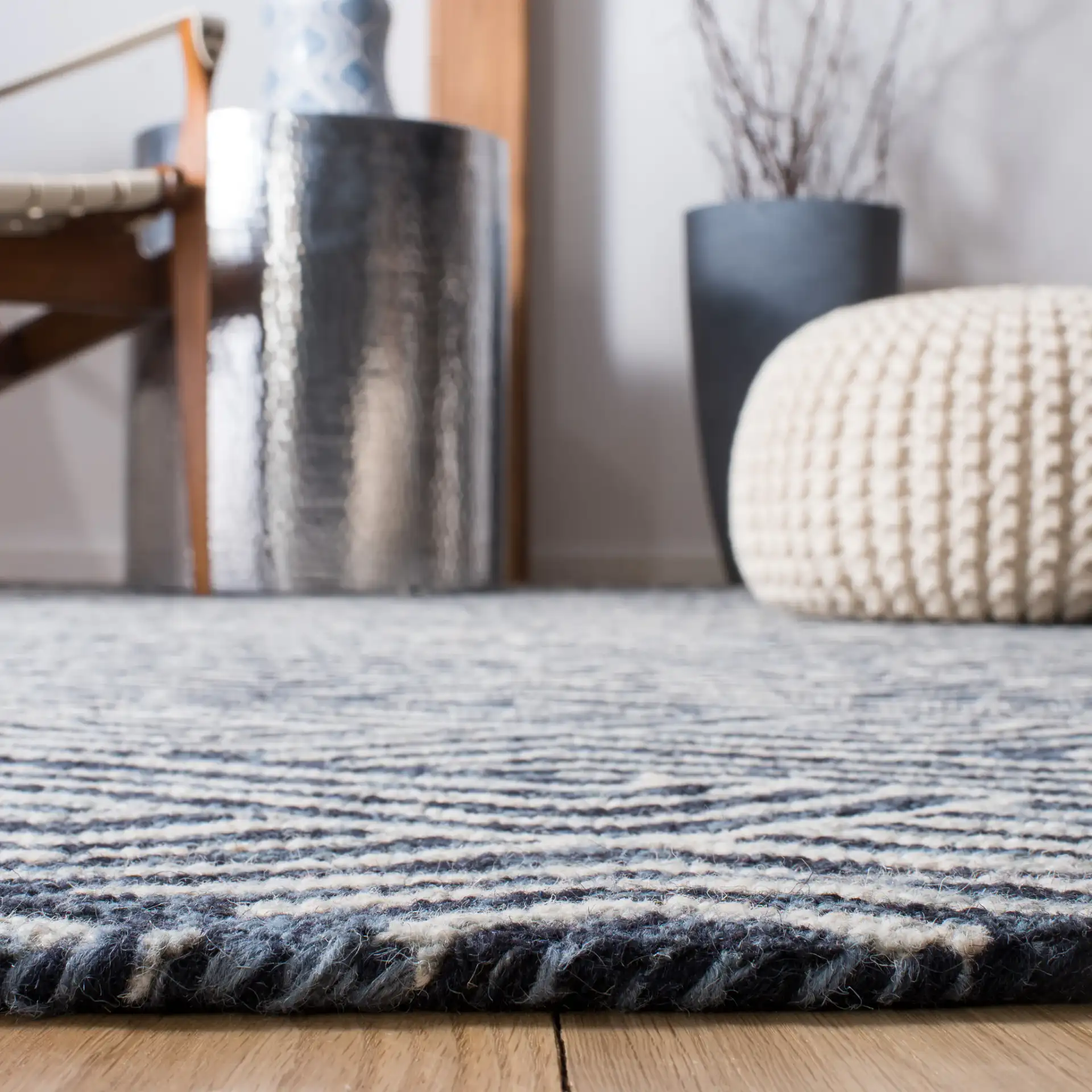Micro-Loop Chevron Fretwork Hand-Tufted Wool Rug in Dark Blue / Ivory in a styled room
