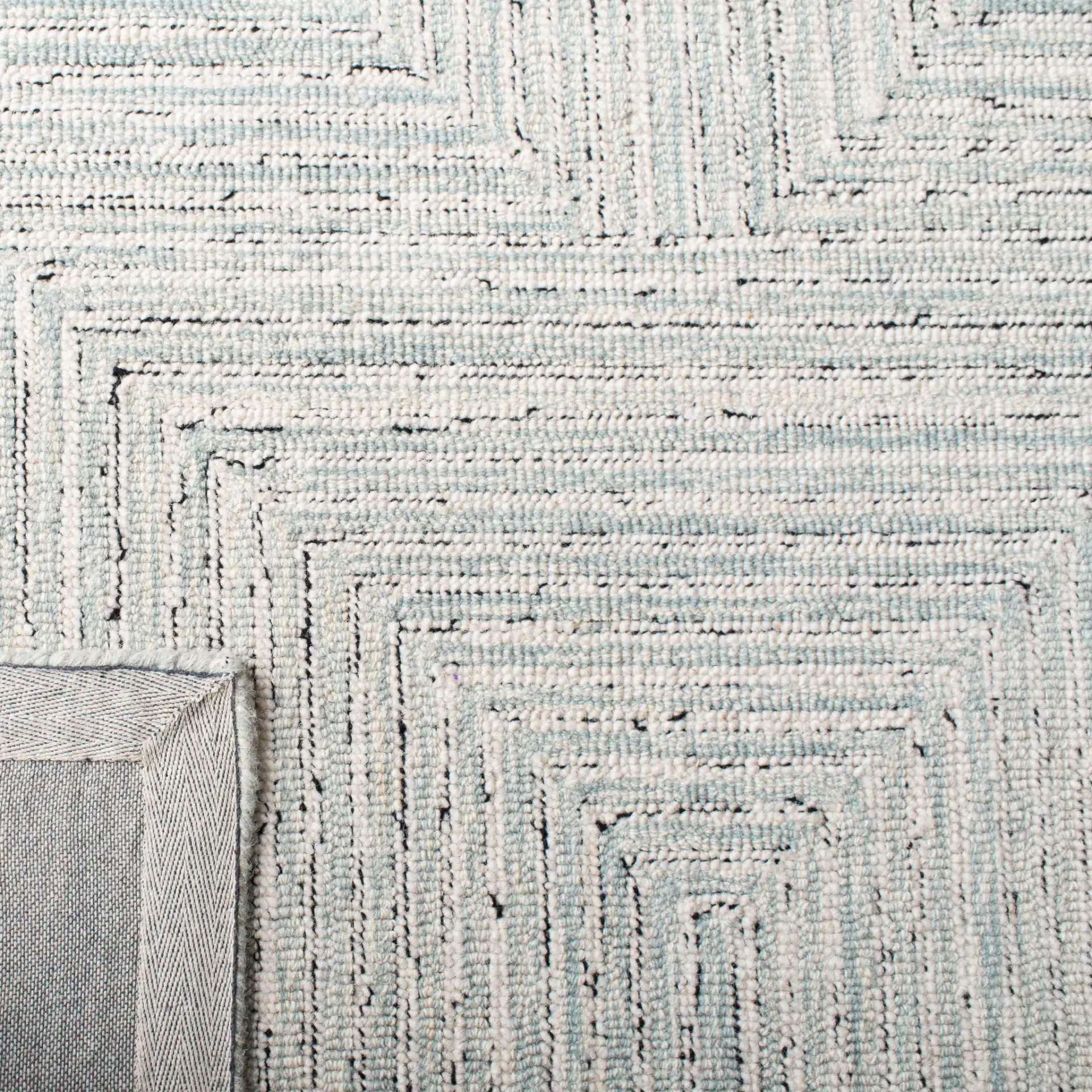 Micro-Loop Concentric Maze Hand-Tufted Wool Rug in Light Gray / Ivory in a styled room