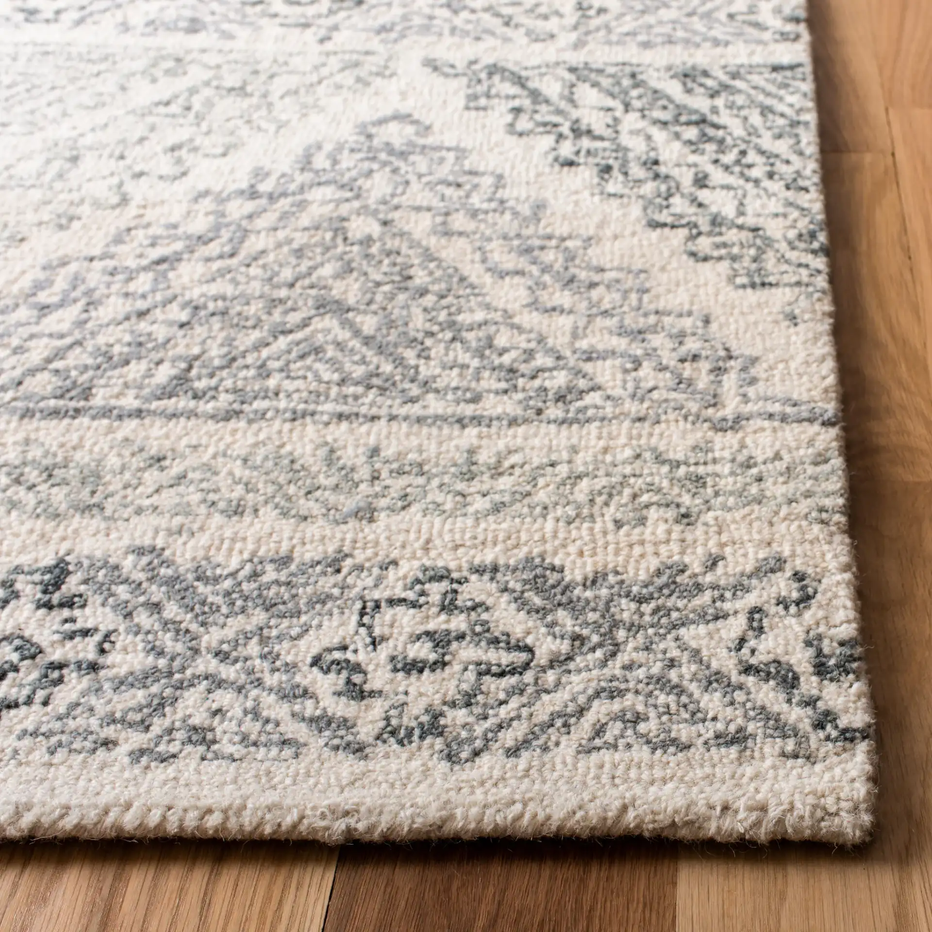 Micro-Loop Banded Geometric Hand-Tufted Rug in Ivory / Gray in a styled room