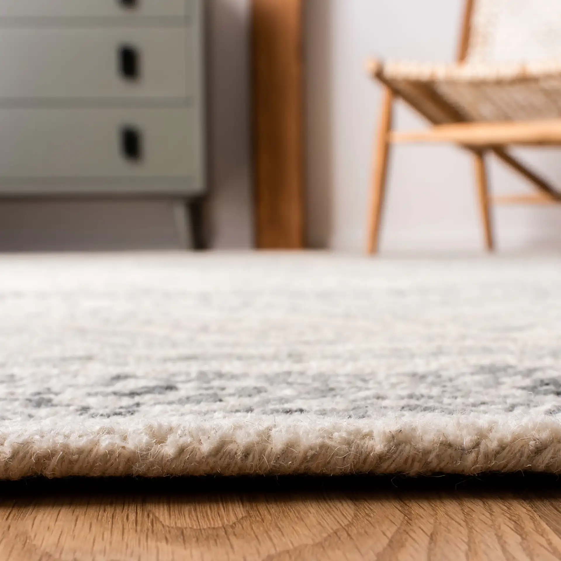 Micro-Loop Banded Geometric Hand-Tufted Rug in Ivory / Gray in a styled room