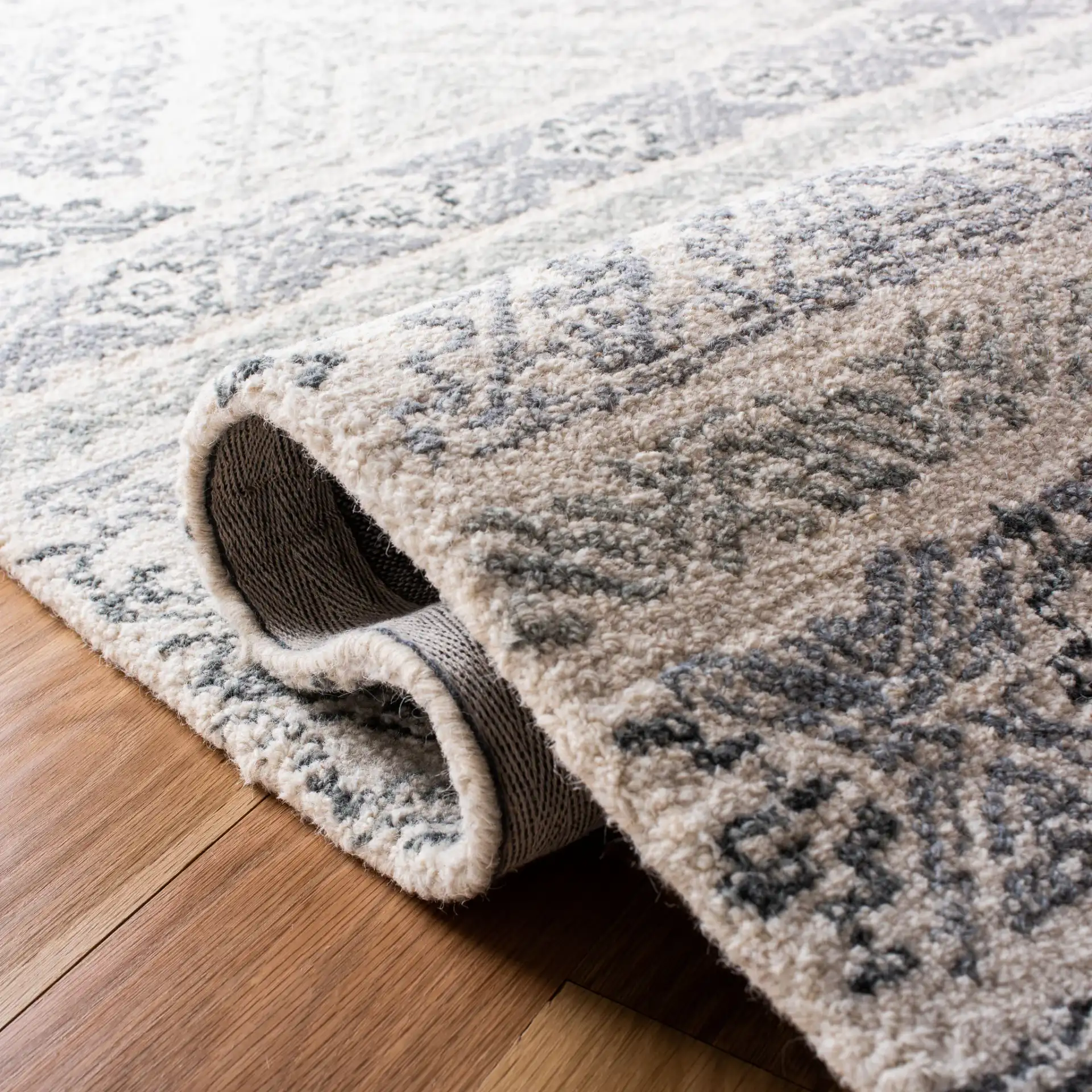 Micro-Loop Banded Geometric Hand-Tufted Rug in Ivory / Gray in a styled room