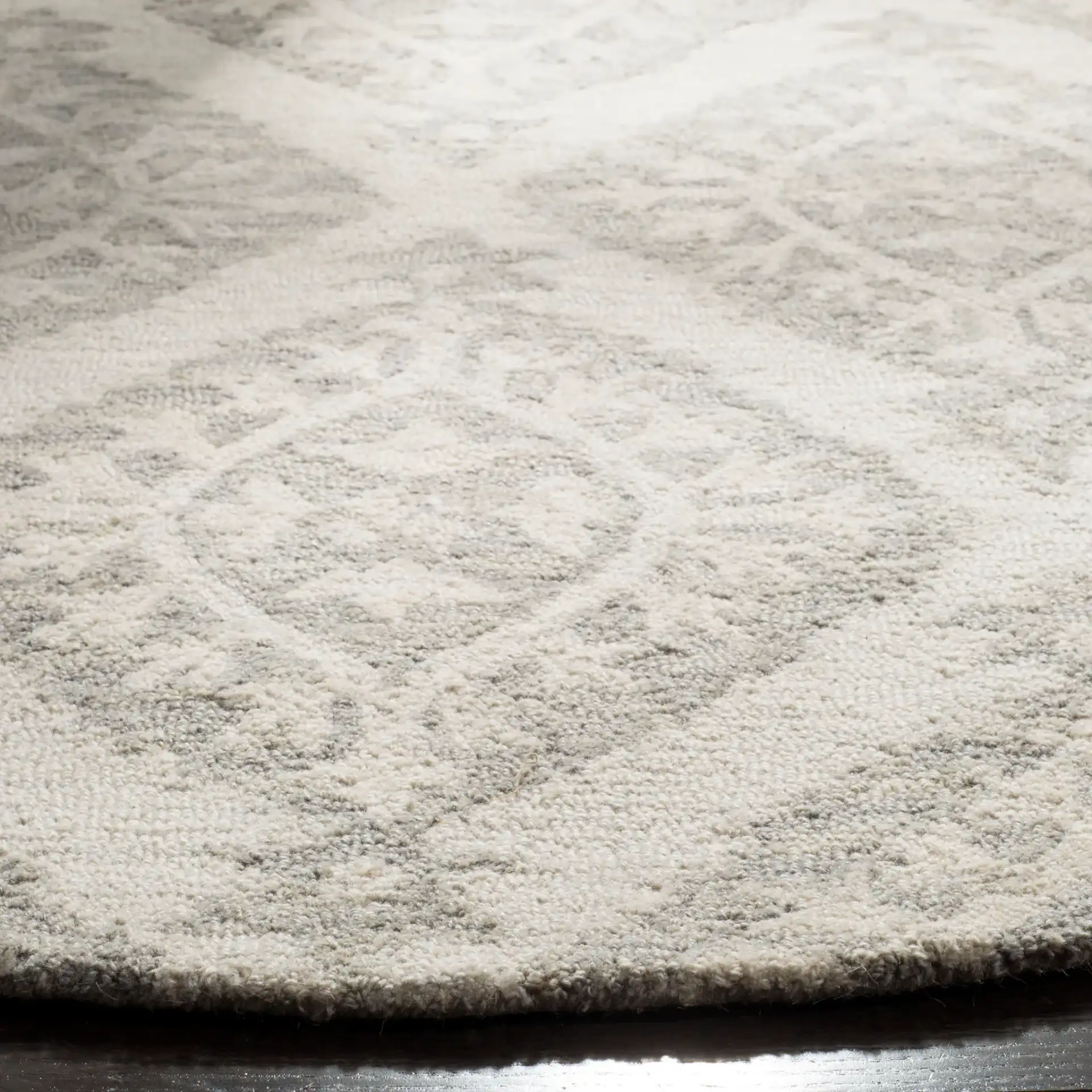 Micro-Loop Diamond Medallion Hand-Tufted Wool Rug in Light Gray in a styled room