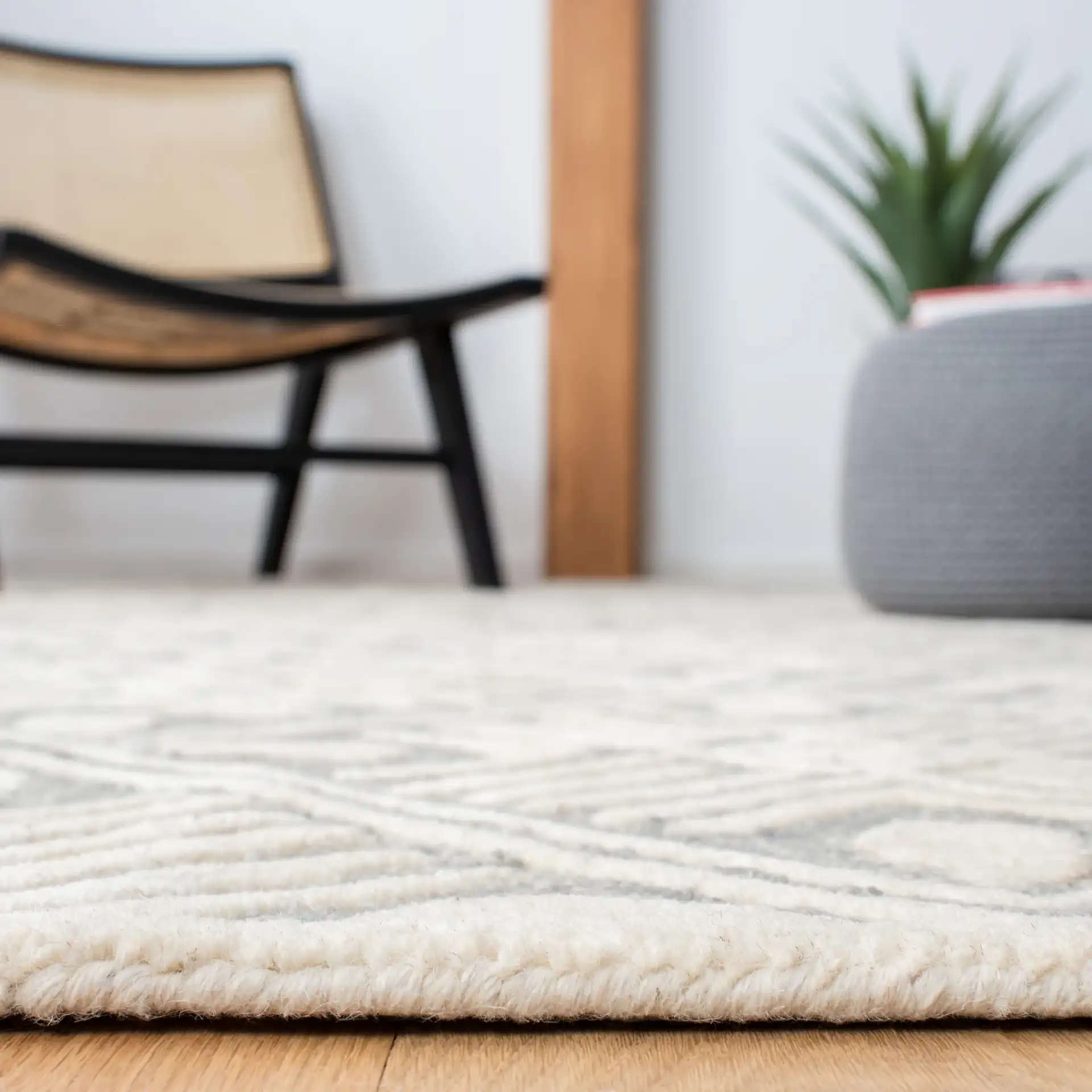 Micro-Loop Diamond Grid Hand-Tufted Wool Rug in Gray / Ivory in a styled room