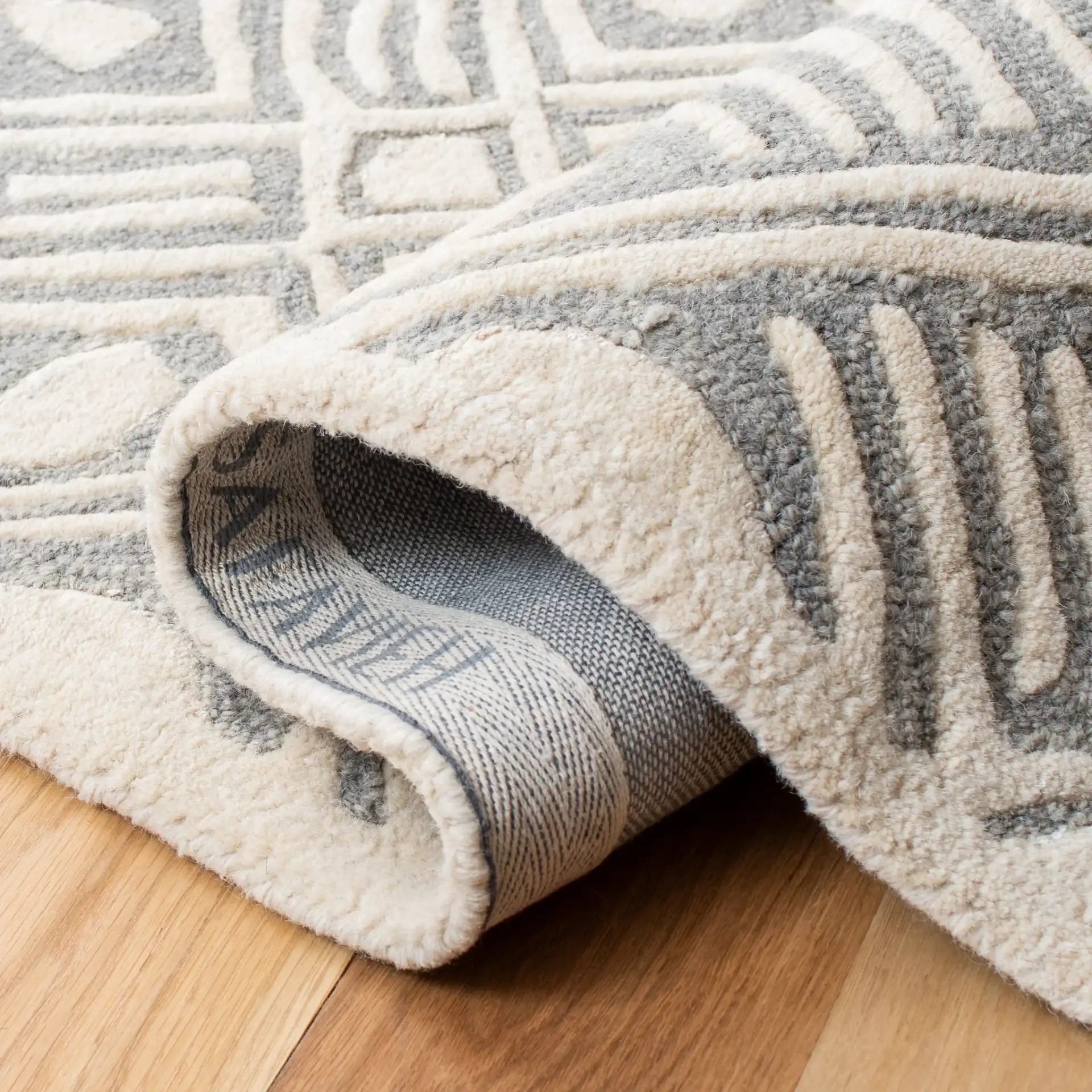 Micro-Loop Diamond Grid Hand-Tufted Wool Rug in Gray / Ivory in a styled room
