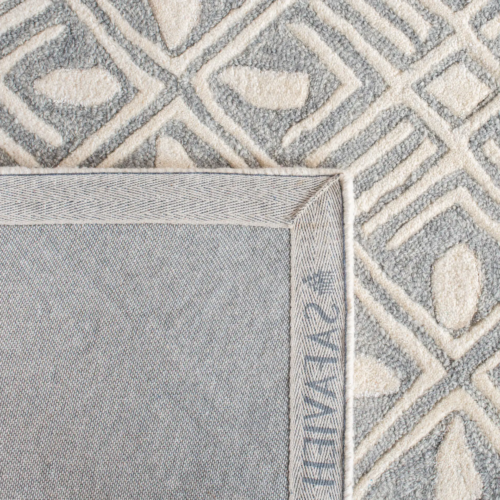 Micro-Loop Diamond Grid Hand-Tufted Wool Rug in Gray / Ivory in a styled room