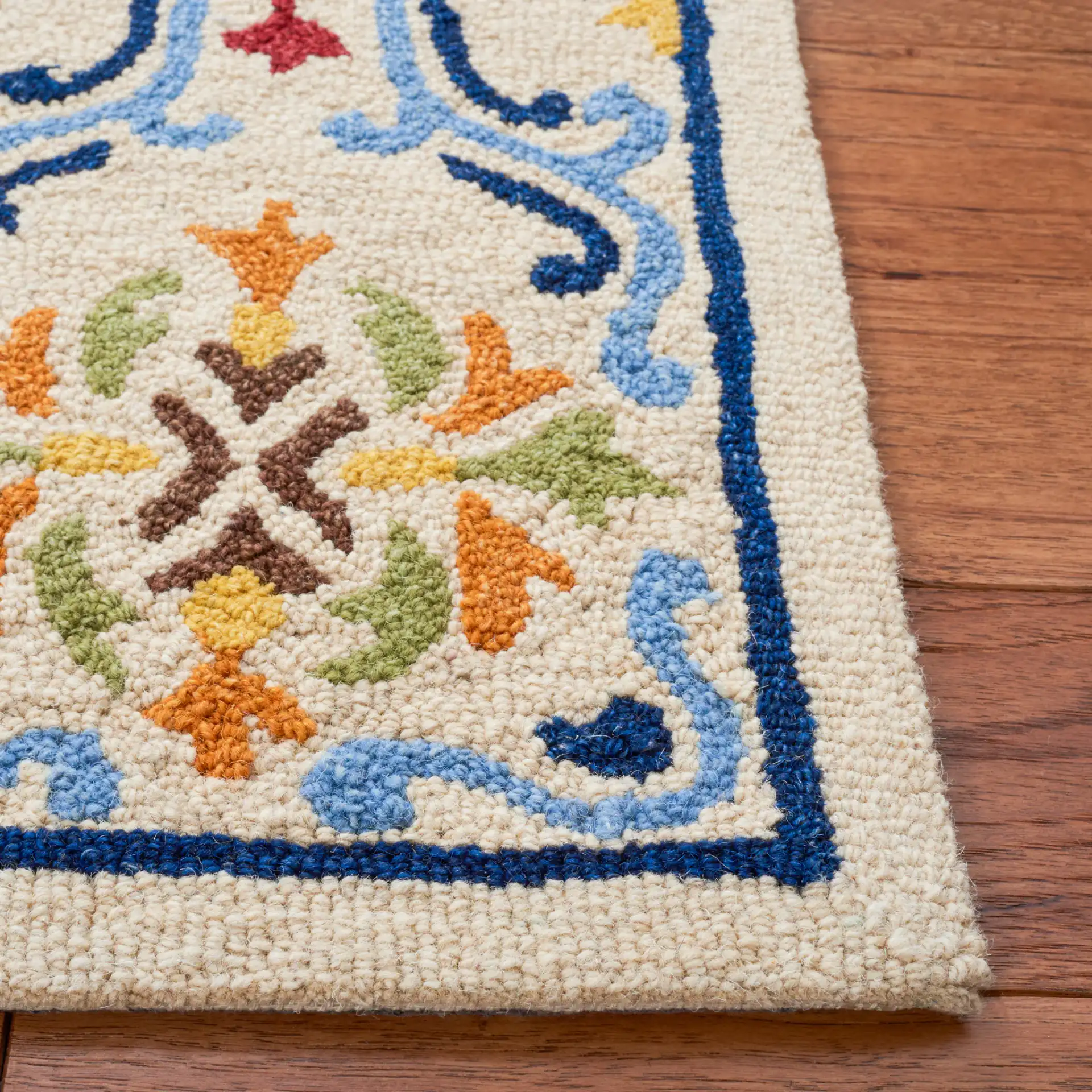 Micro-Loop Scrolling Floral Hand-Tufted Wool Rug in Beige / Blue in a styled room
