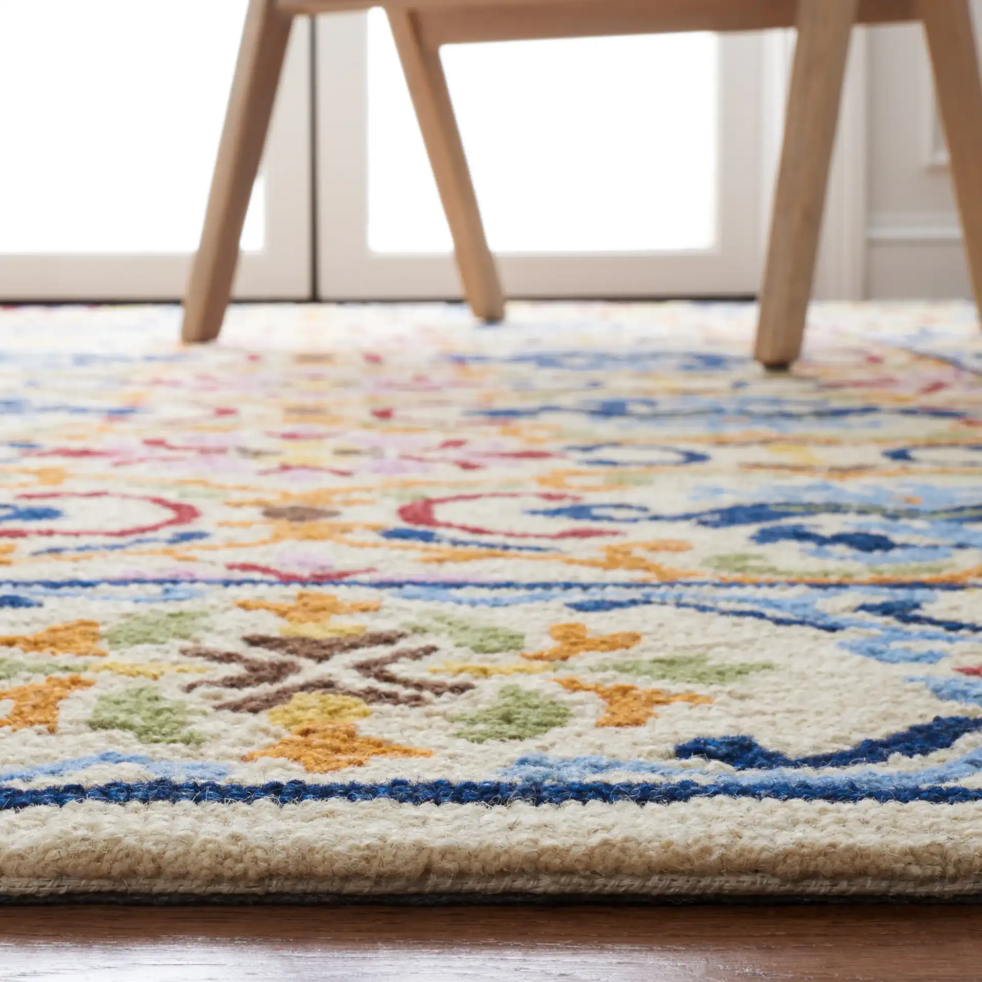 Micro-Loop Scrolling Floral Hand-Tufted Wool Rug in Beige / Blue in a styled room