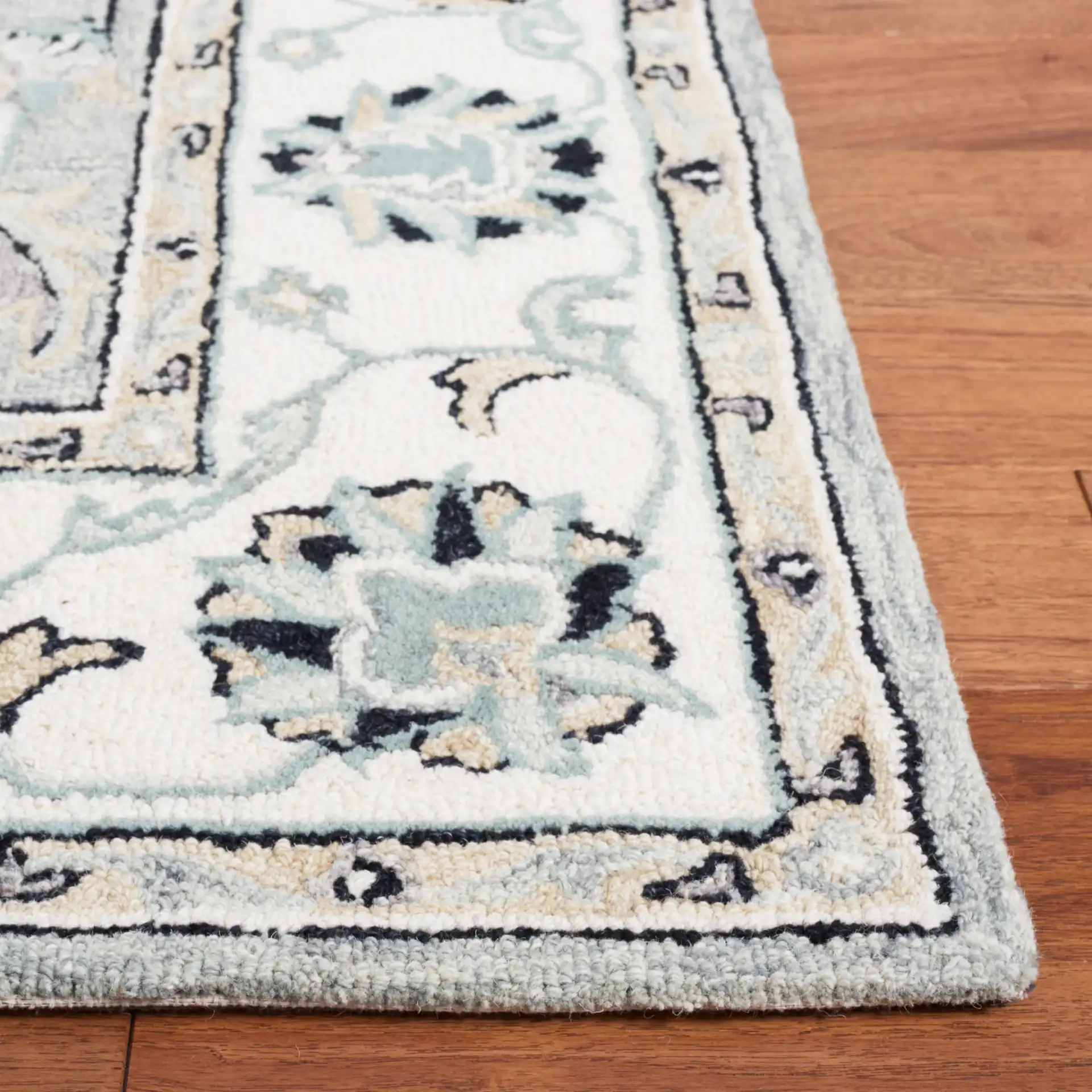 Micro-Loop Palmette Border Hand-Tufted Wool Rug in Gray / Ivory in a styled room