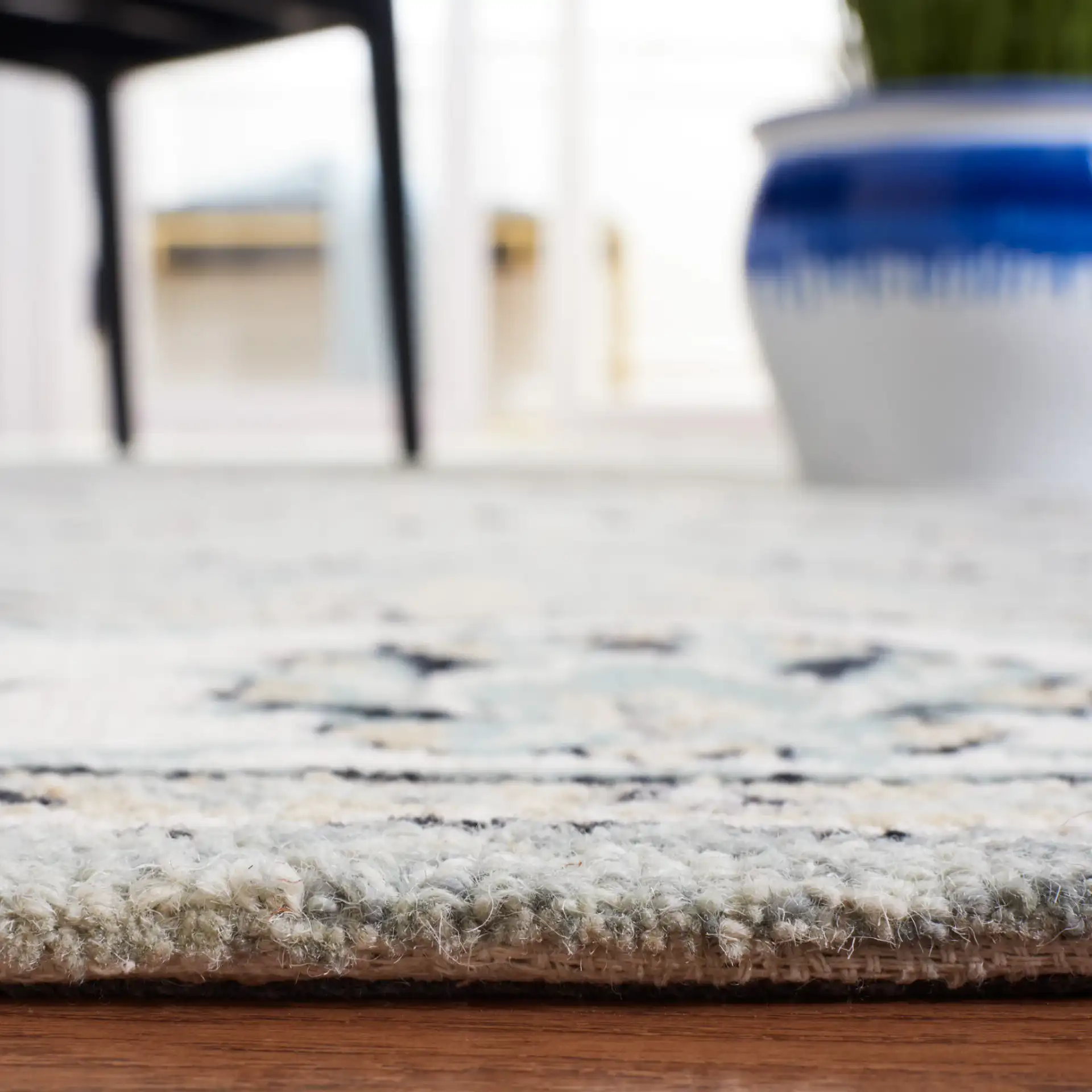 Micro-Loop Palmette Border Hand-Tufted Wool Rug in Gray / Ivory in a styled room