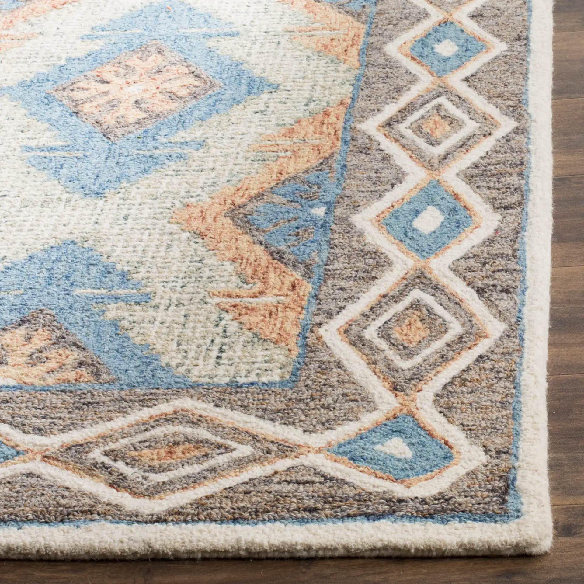 Micro-Loop Micro Loop Southwestern Diamond Hand-Tufted Wool Rug in Blue / Beige in a styled room