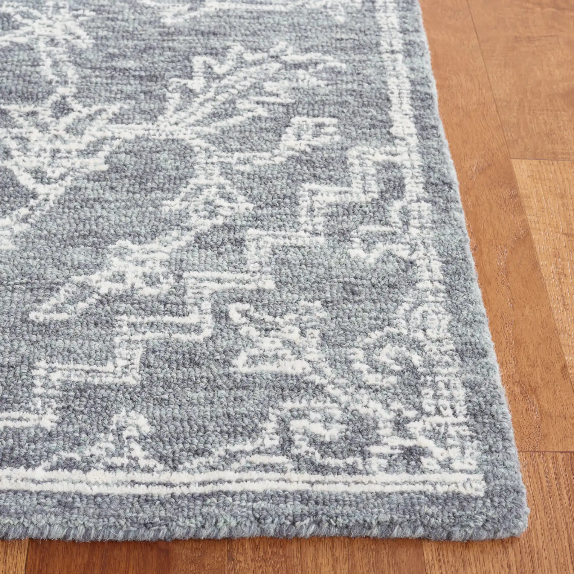 Micro-Loop Medallion Wool Rug in Gray / Ivory in a styled room