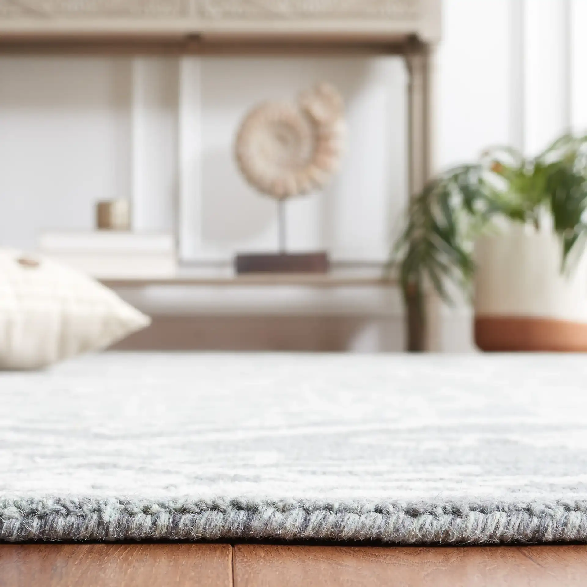 Micro-Loop Medallion Wool Rug in Gray / Ivory in a styled room