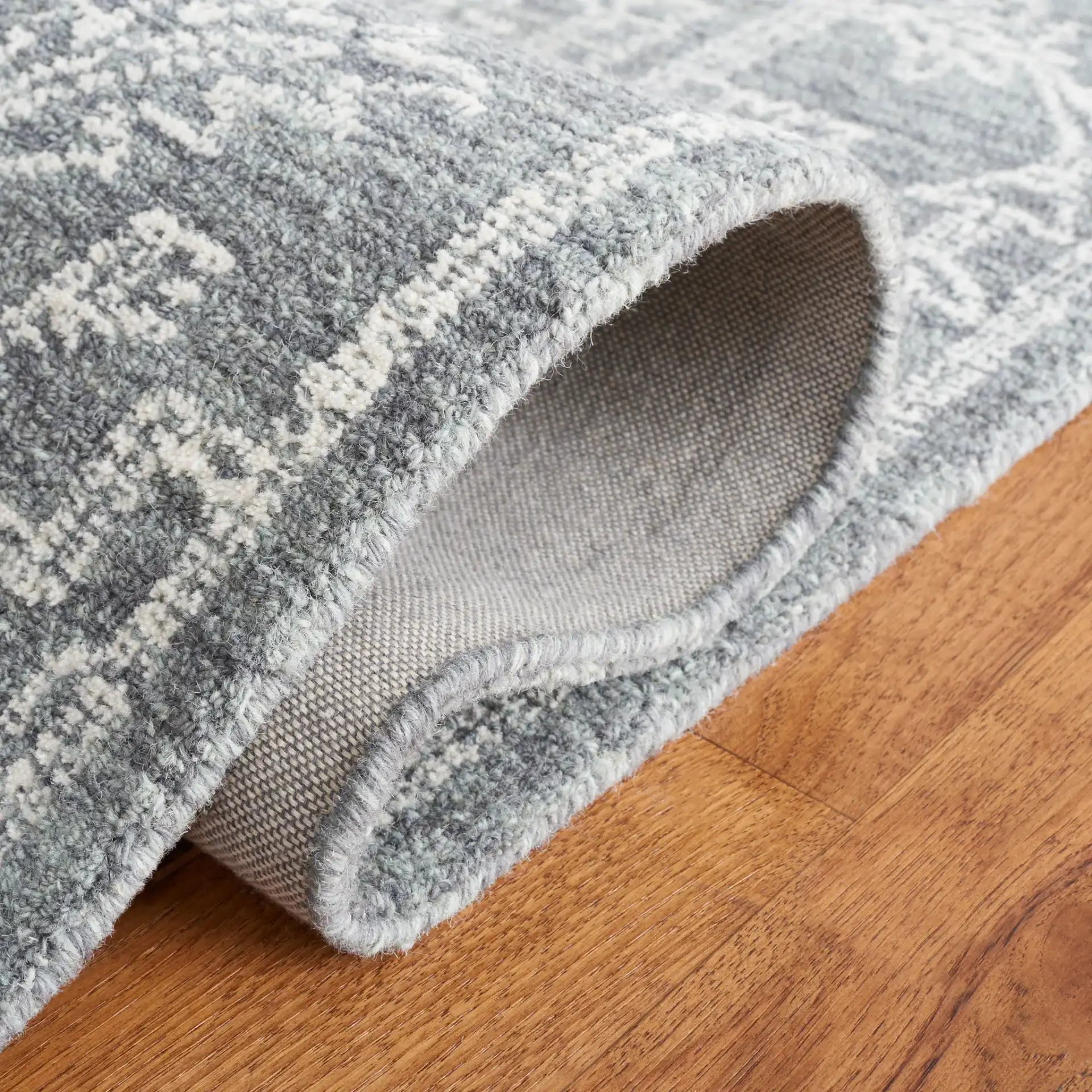Micro-Loop Medallion Wool Rug in Gray / Ivory in a styled room