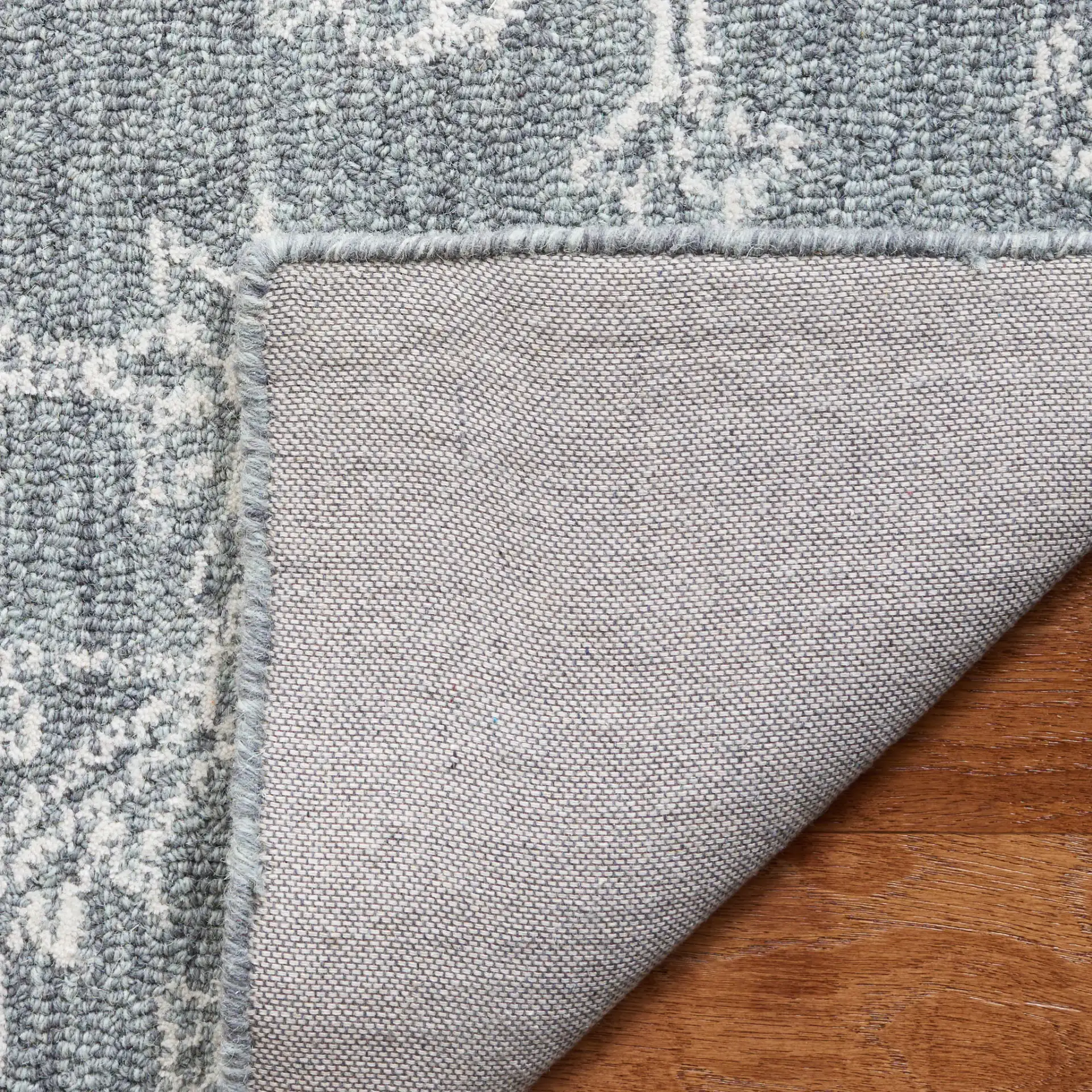 Micro-Loop Medallion Wool Rug in Gray / Ivory in a styled room